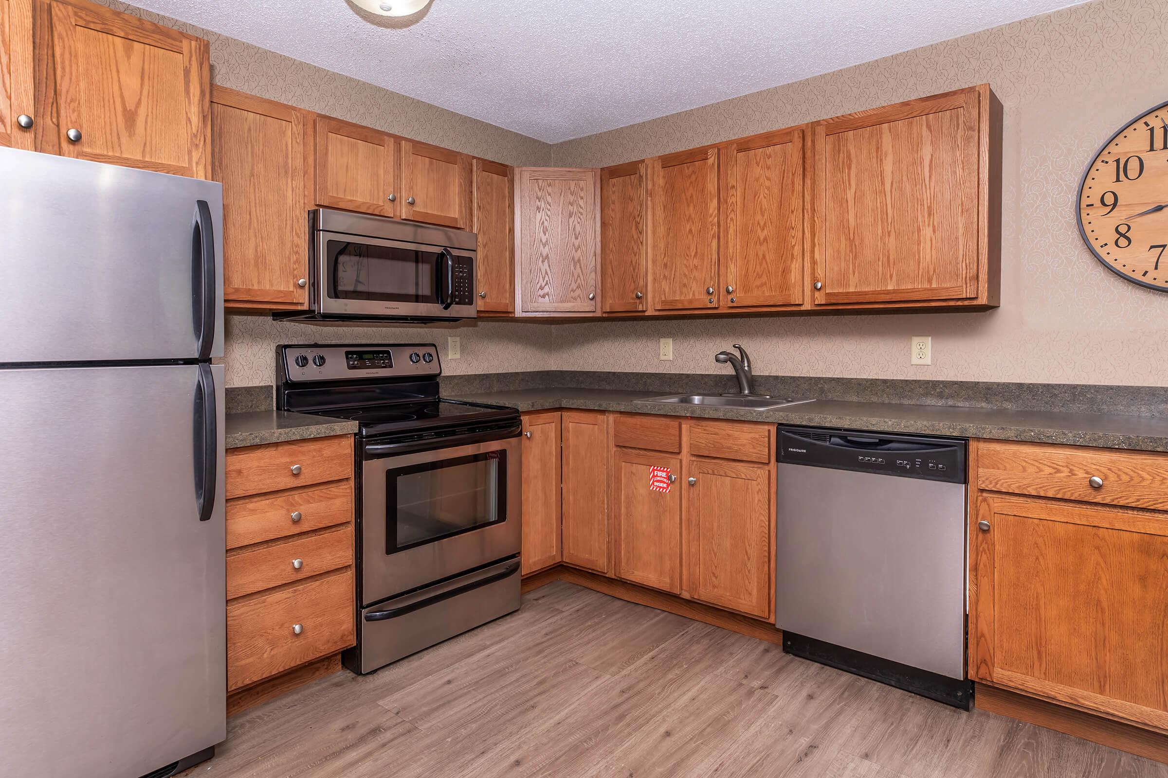 a kitchen with stainless steel appliances and wooden cabinets