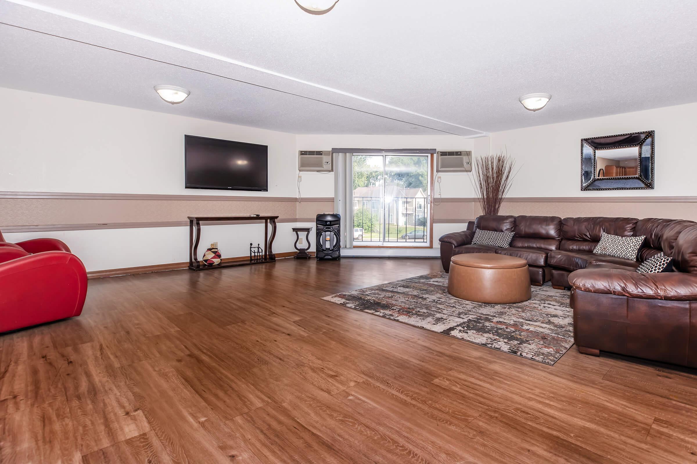 a living room filled with furniture and a flat screen tv