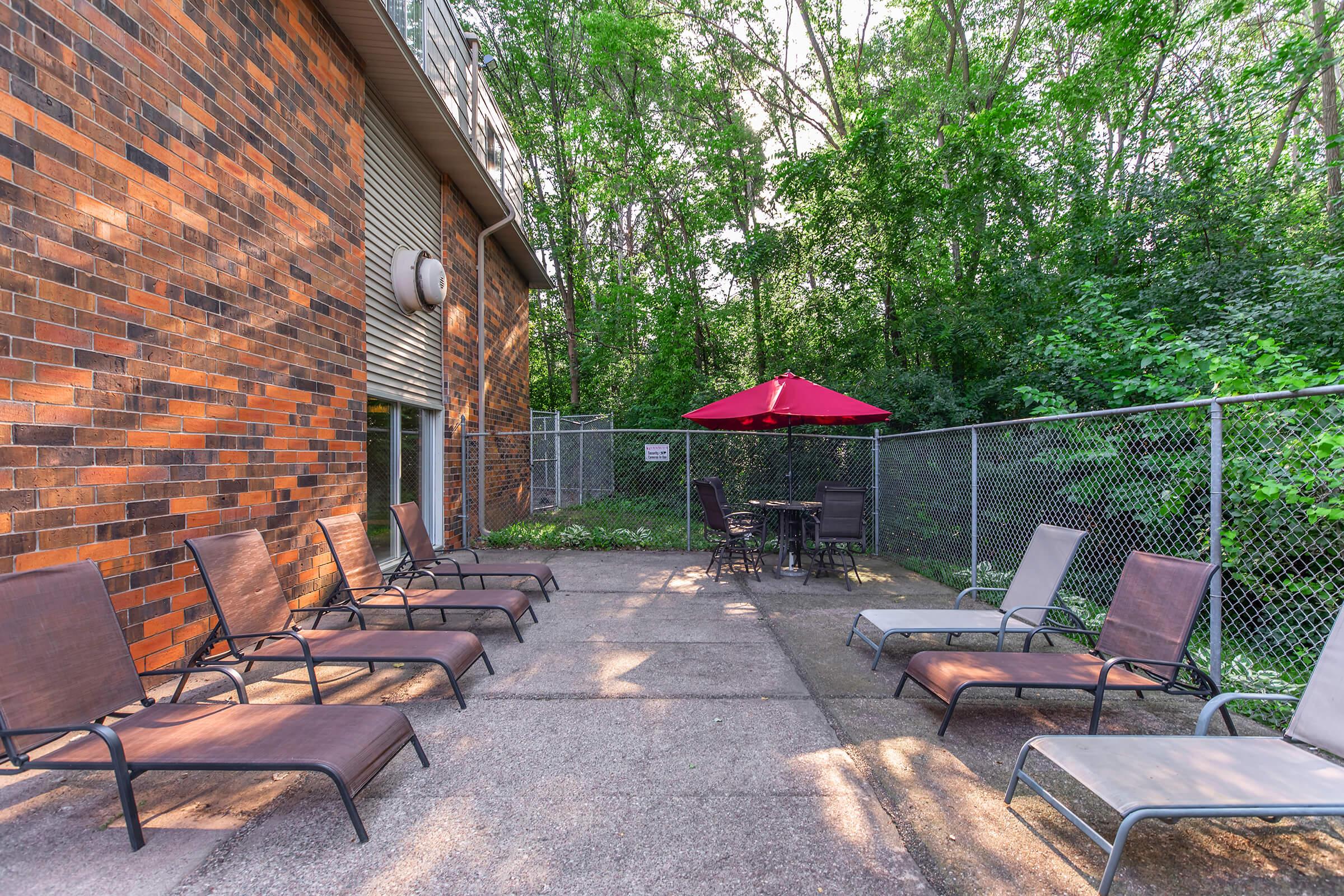 an empty park bench sitting in front of a building