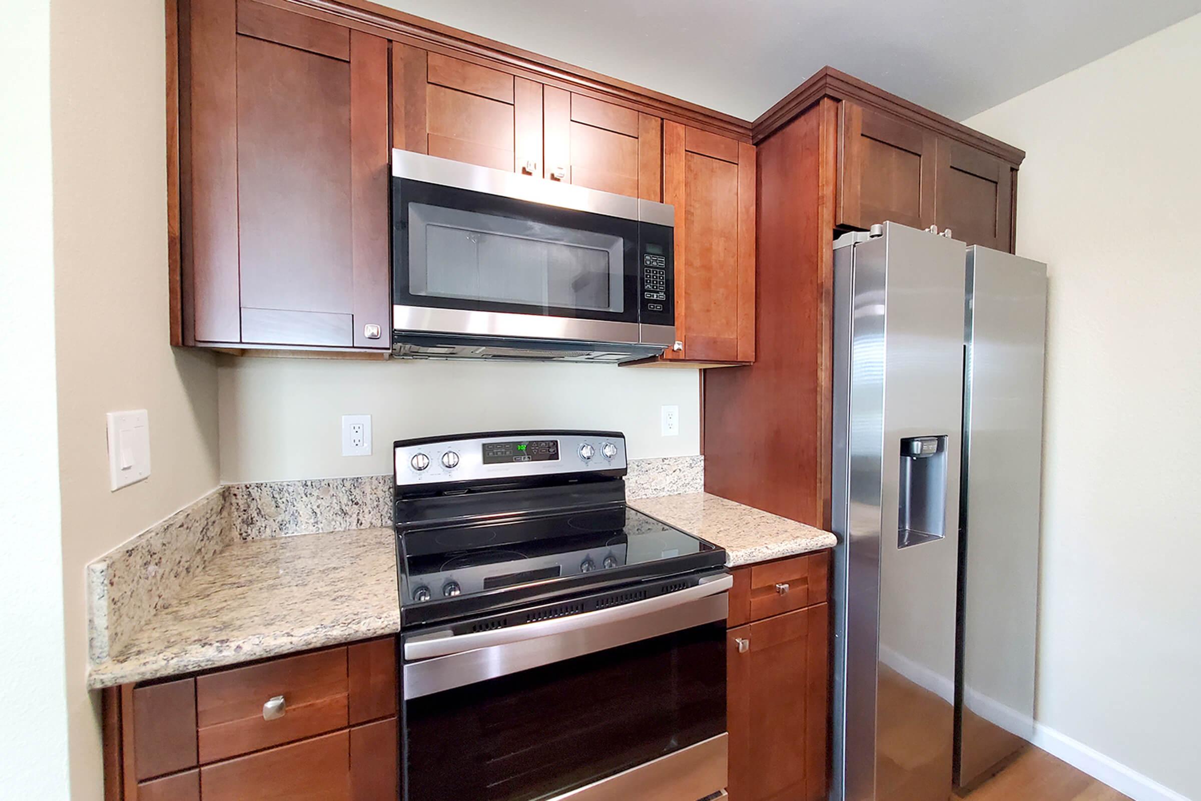 a stove top oven sitting inside of a kitchen