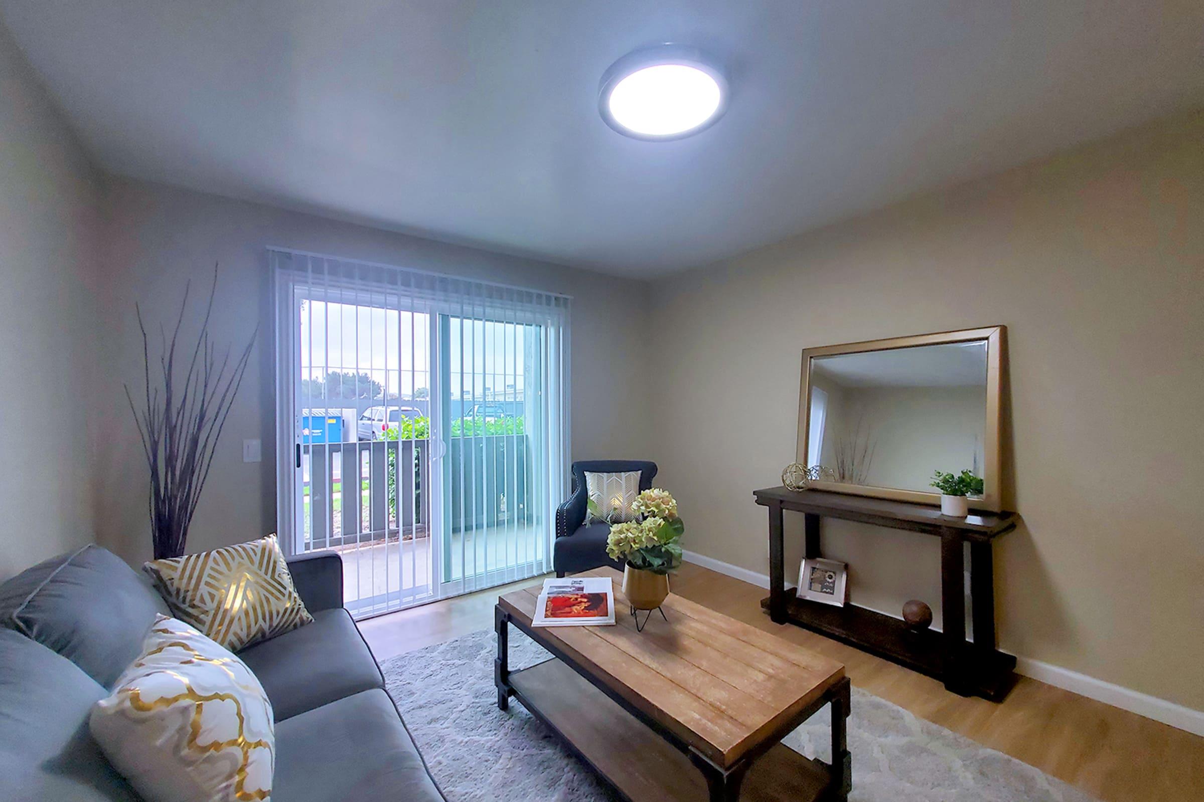 a living room filled with furniture and a large window