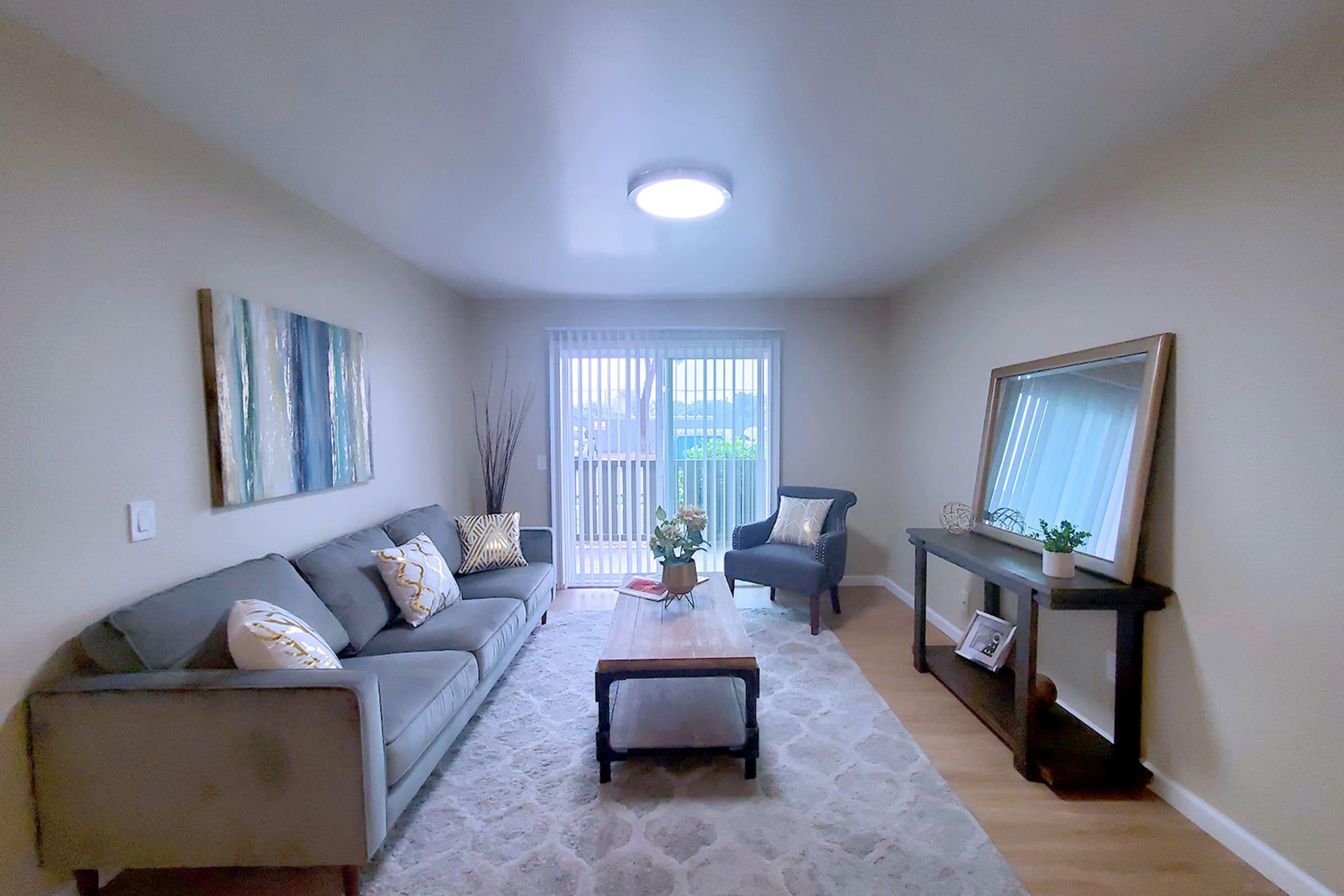 a living room filled with furniture and a large window