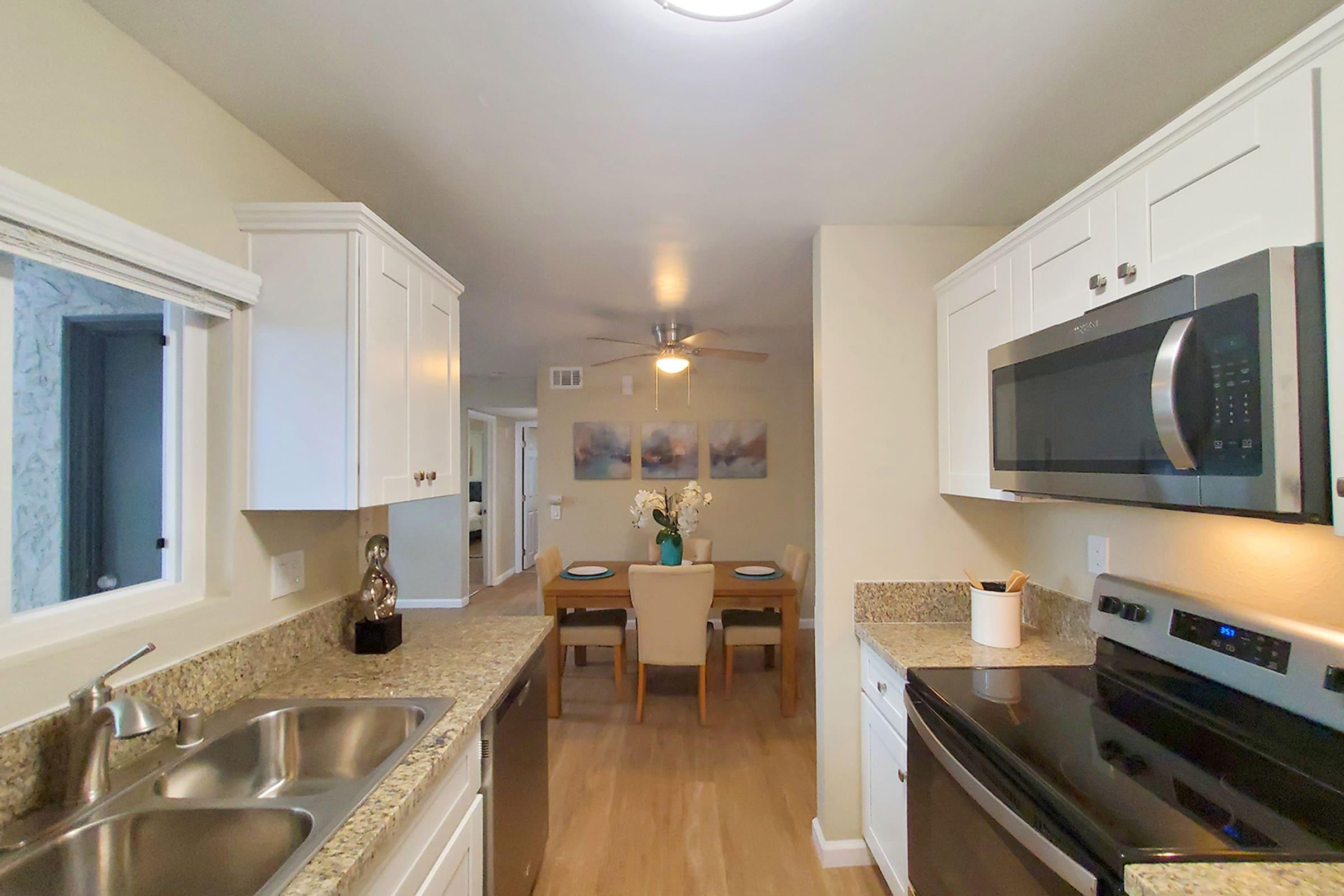 a modern kitchen with stainless steel appliances and wooden cabinets