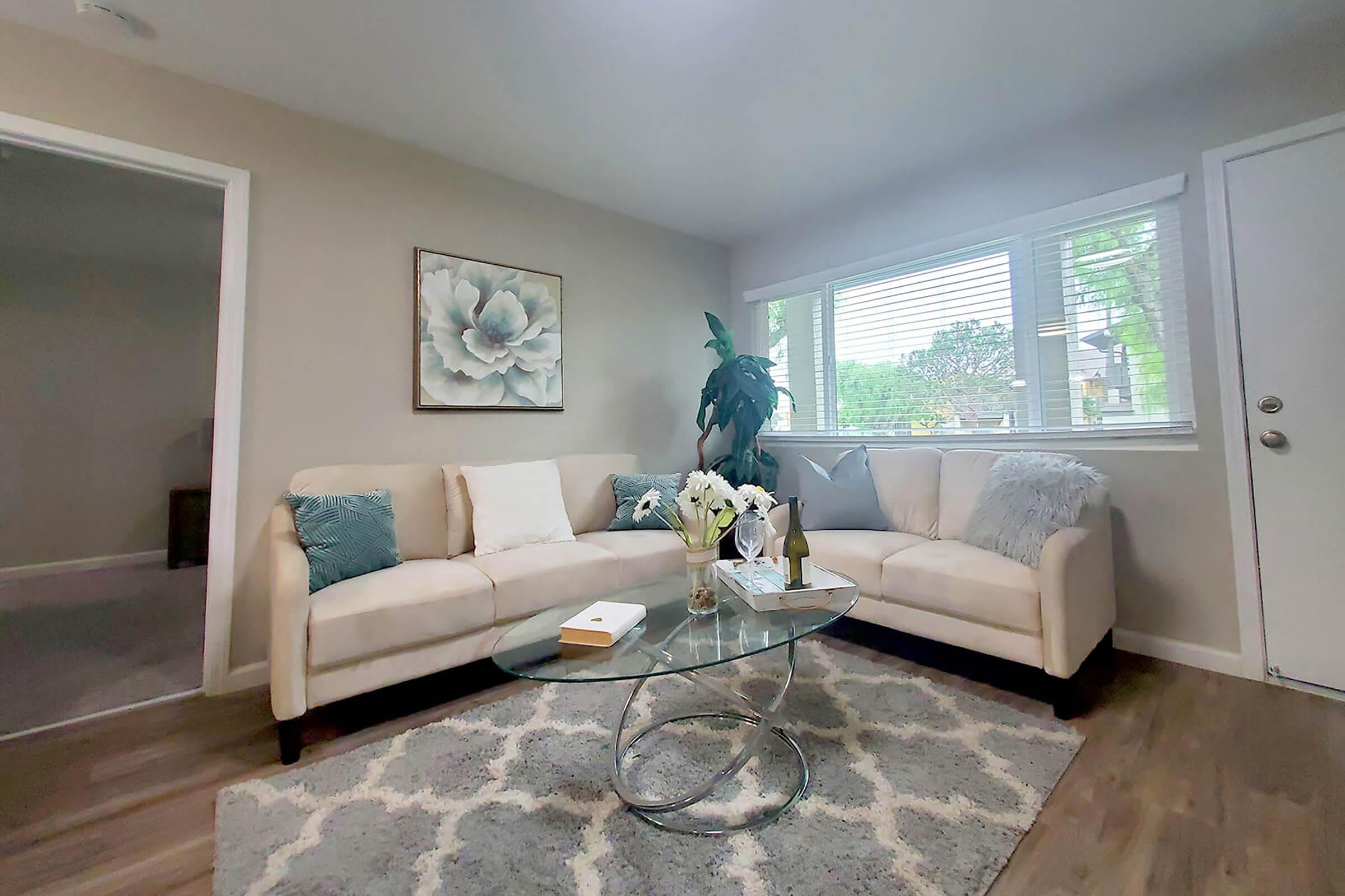 a living room filled with furniture and a large window