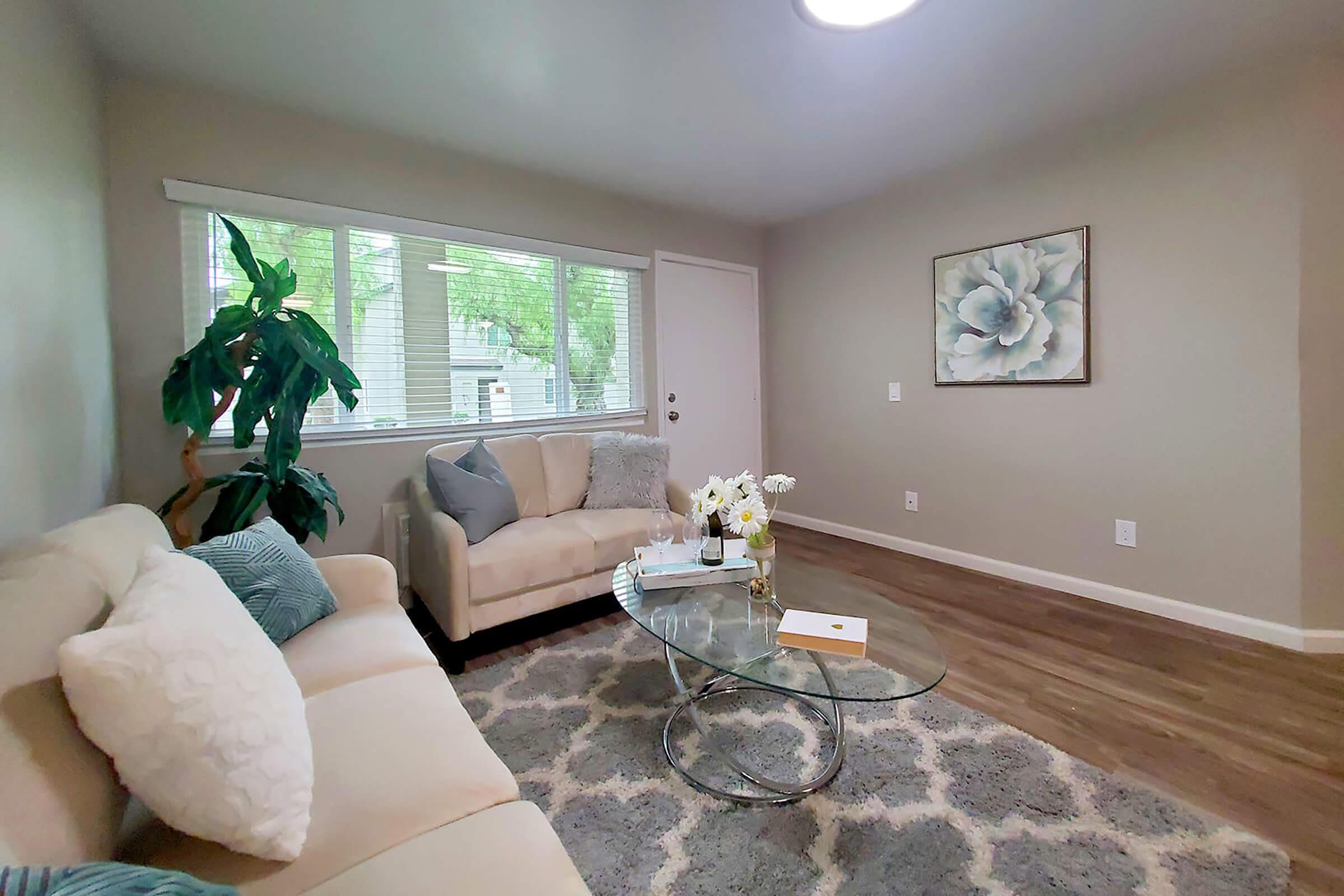 a living room filled with furniture and a large window