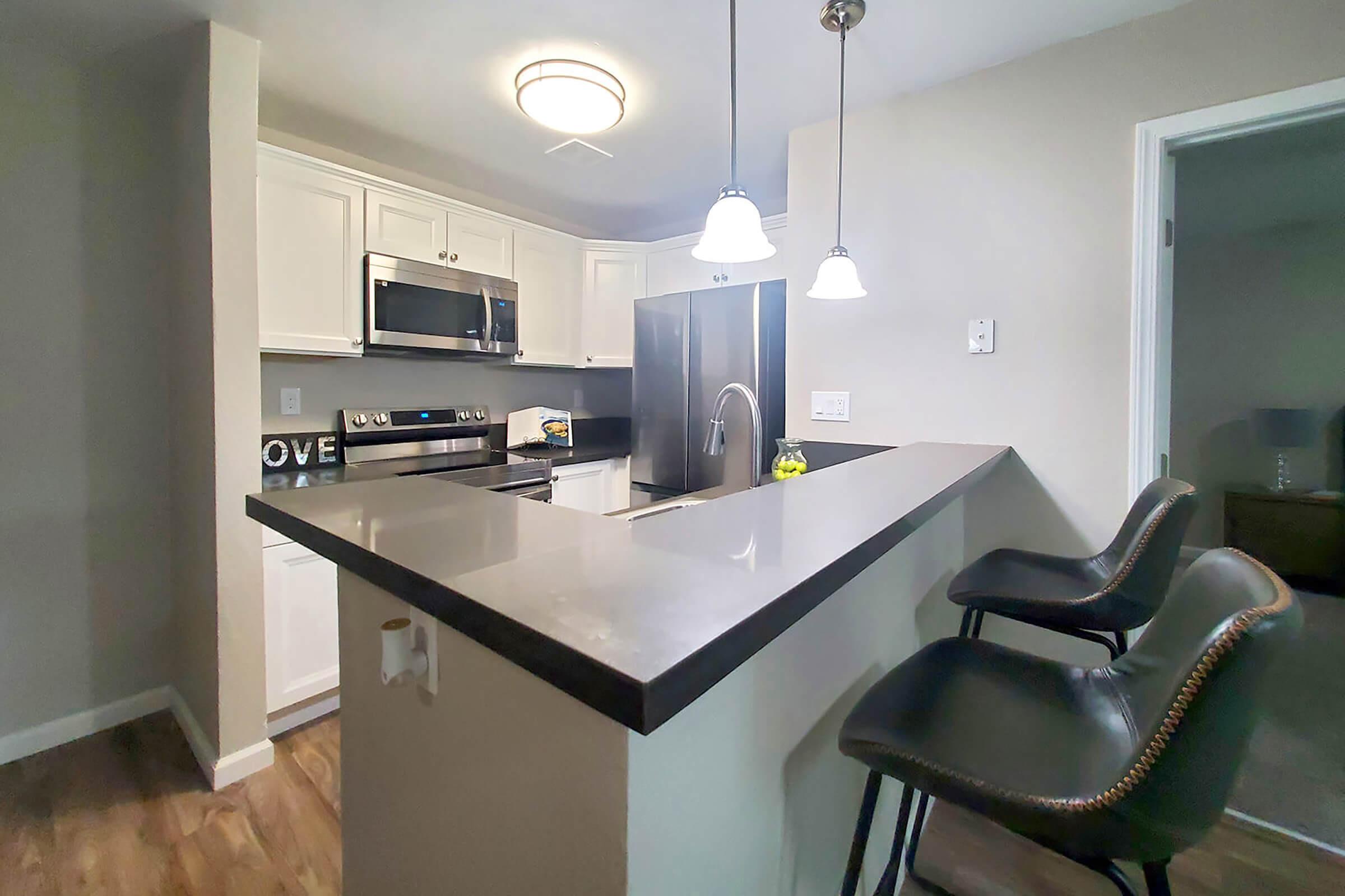 a kitchen with a sink and a mirror