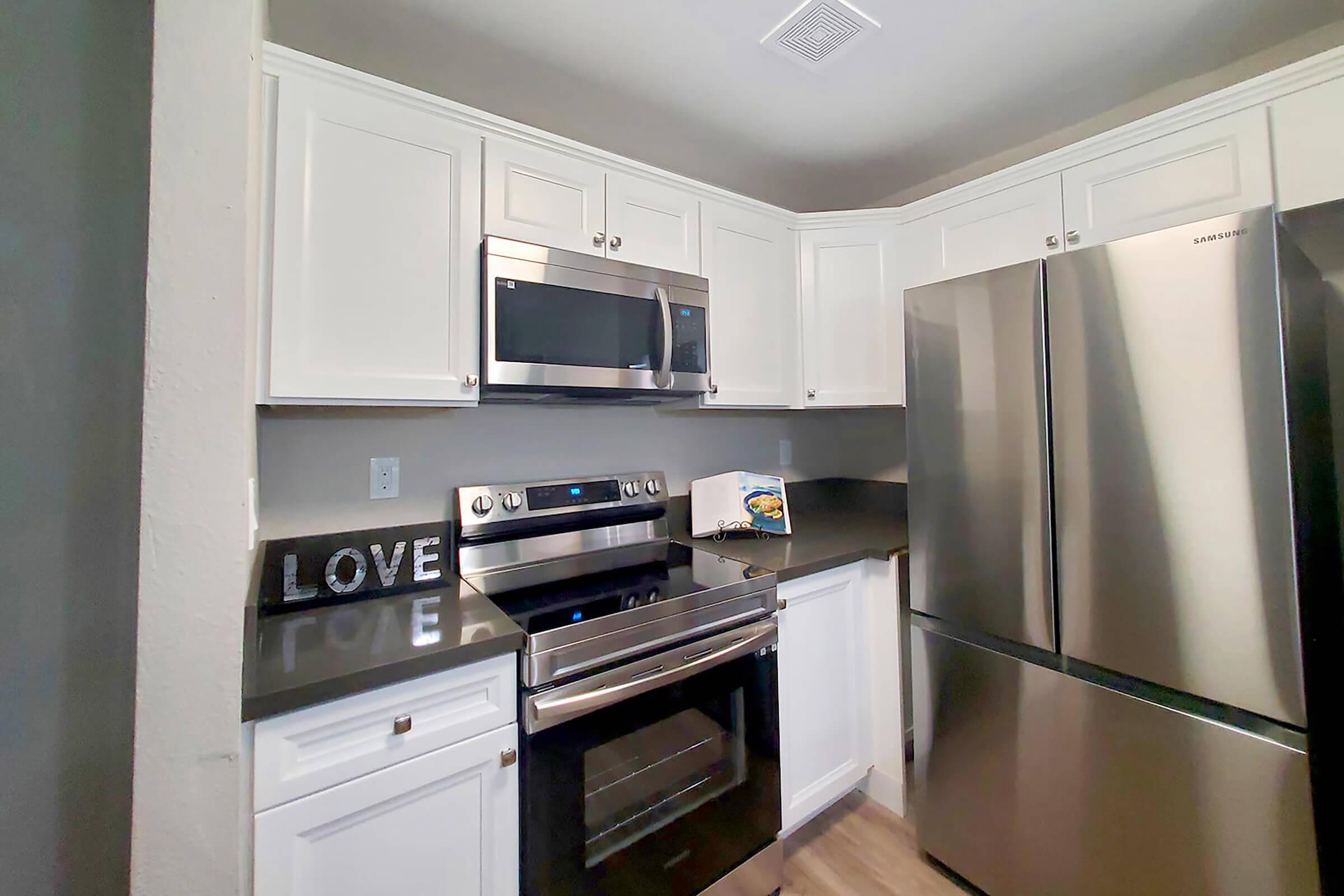 a kitchen with a stove and a refrigerator