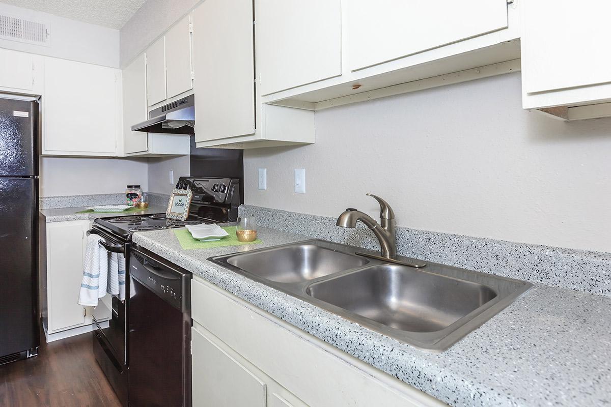 a kitchen with a stove and a sink