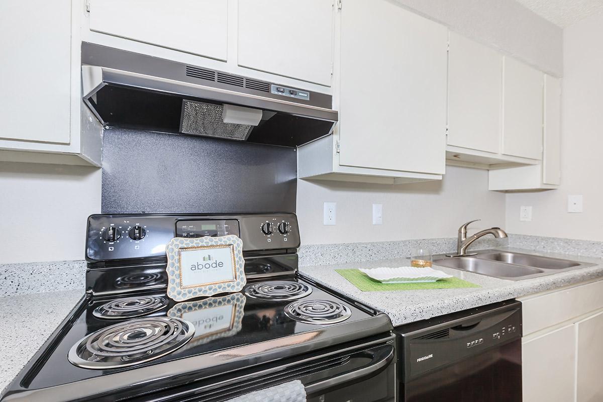 a stove top oven sitting inside of a kitchen