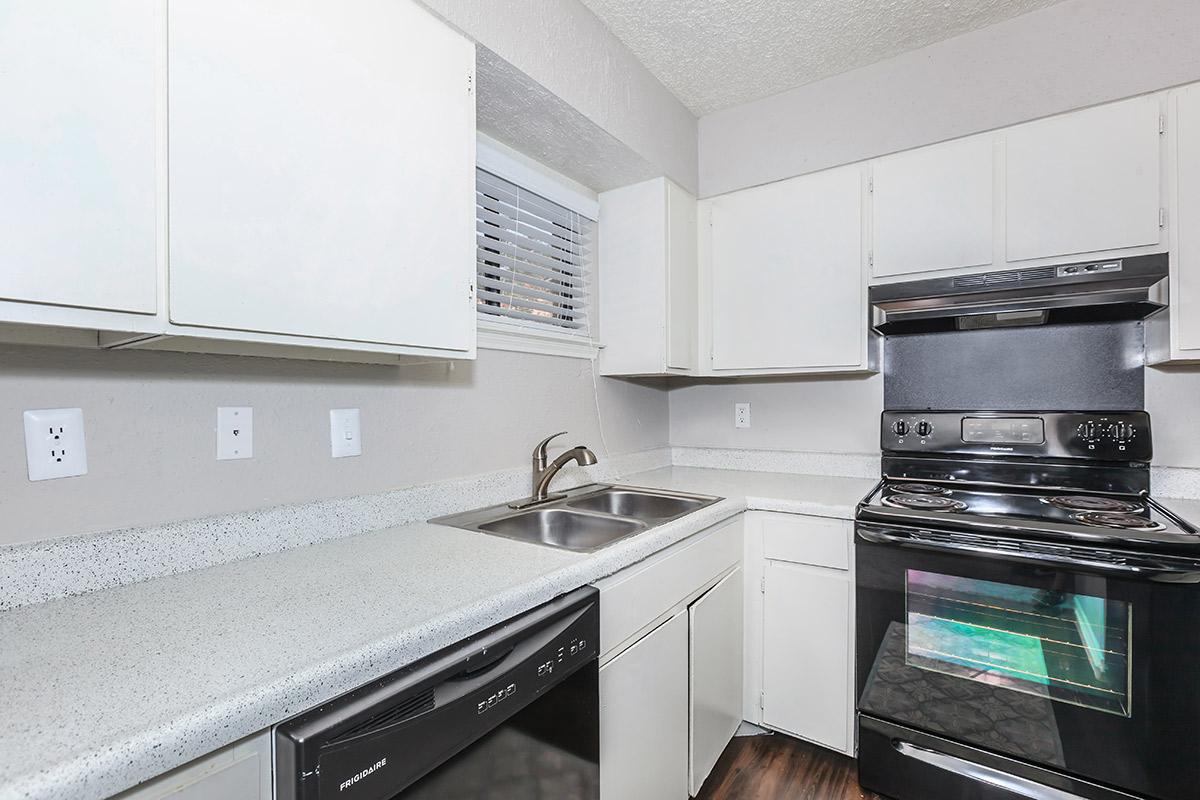 a stove top oven sitting inside of a kitchen