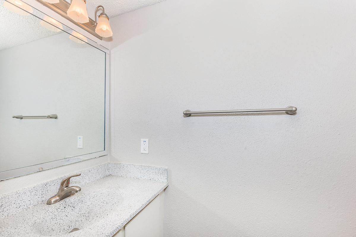 a white sink and a mirror