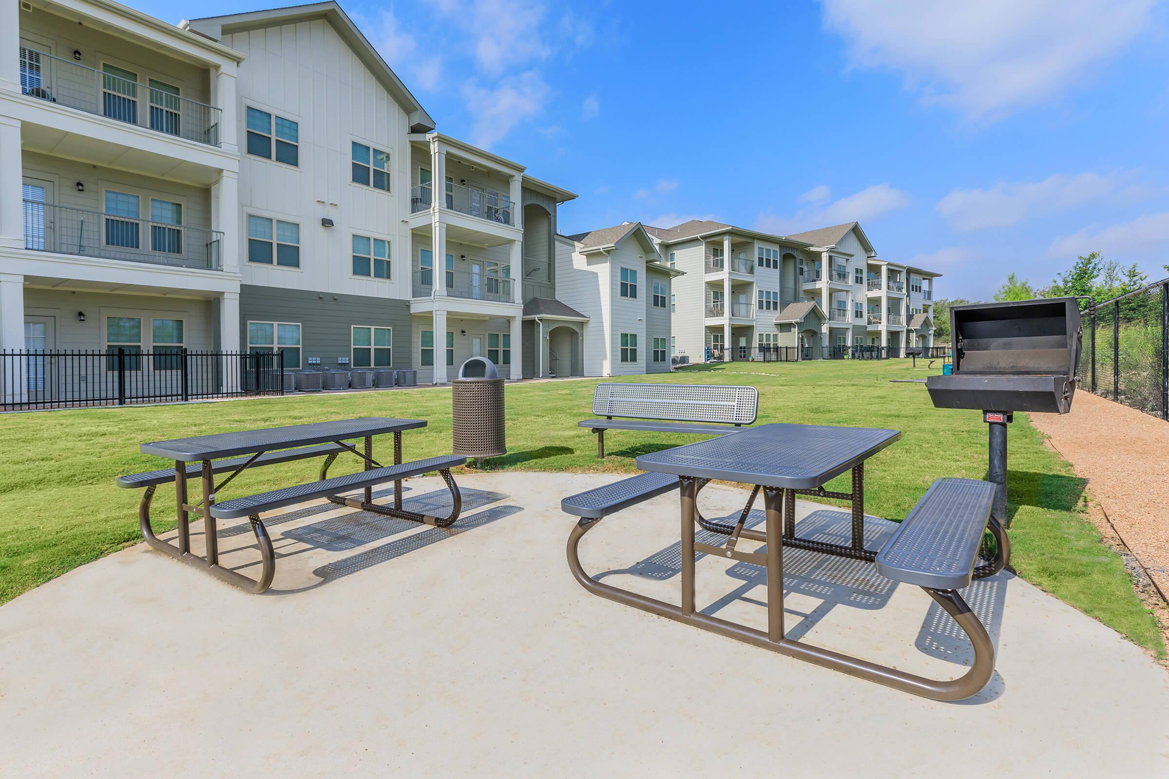 a couple of lawn chairs sitting on a bench in front of a building