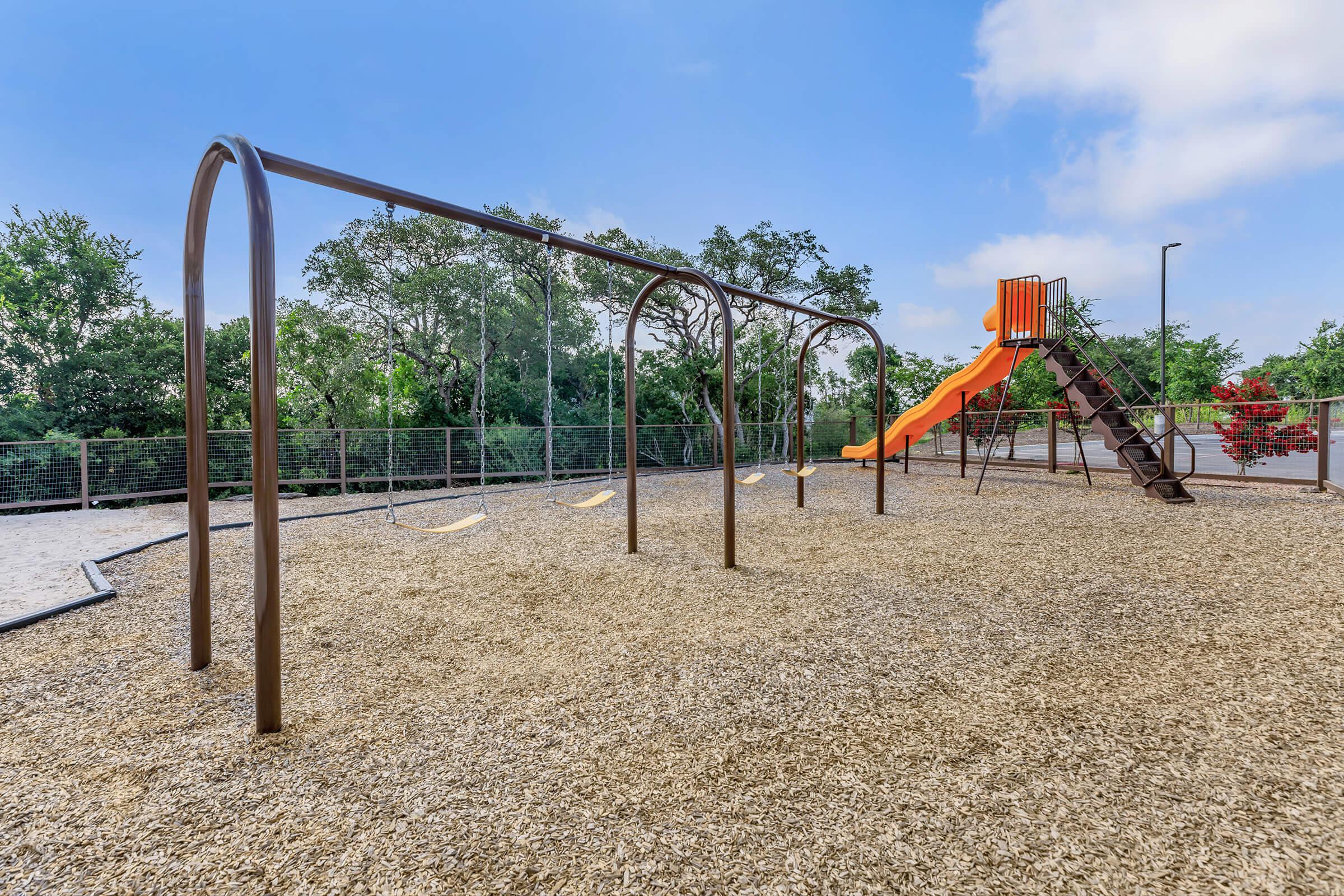 a playground in front of a palm tree