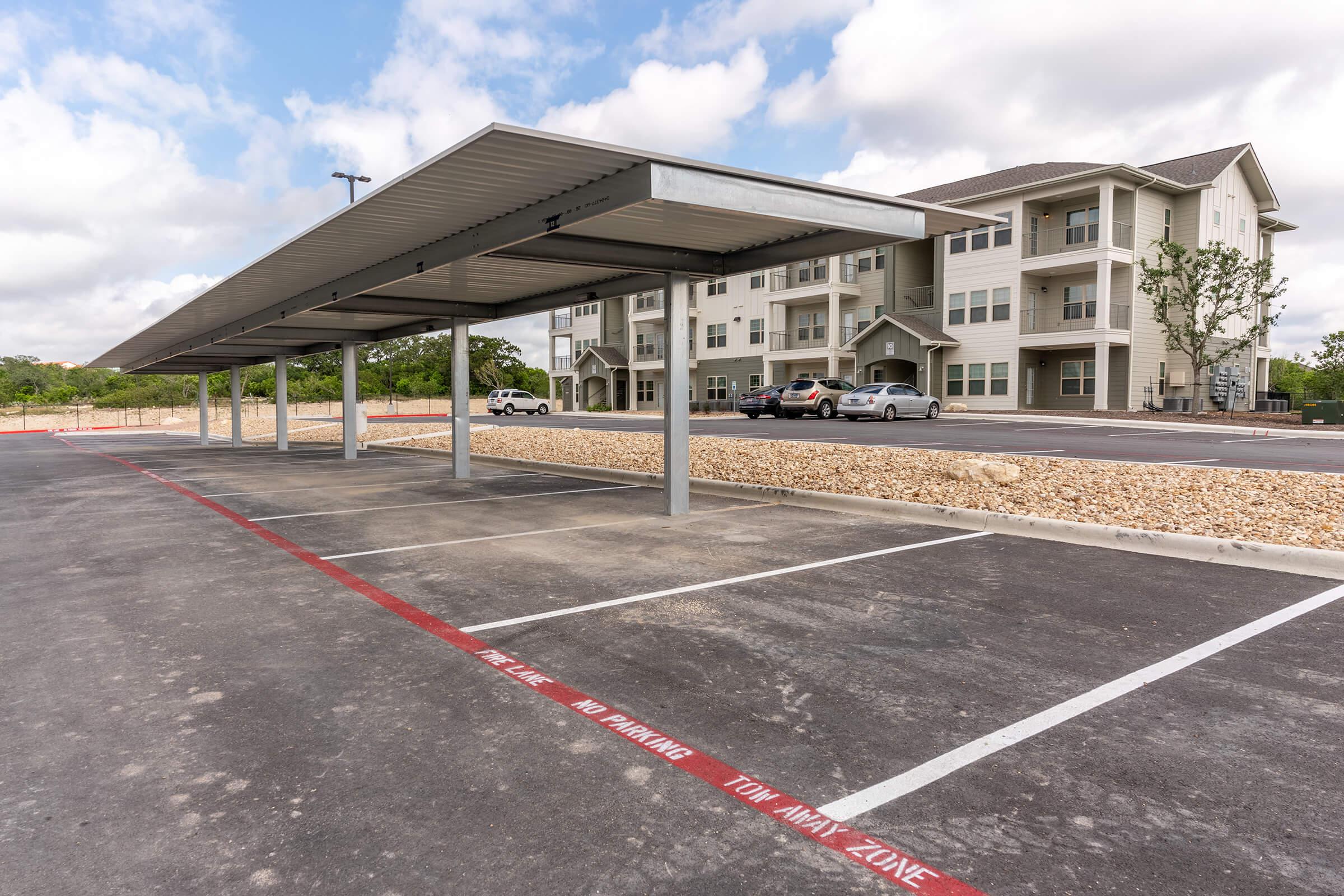 an empty parking lot in front of a house