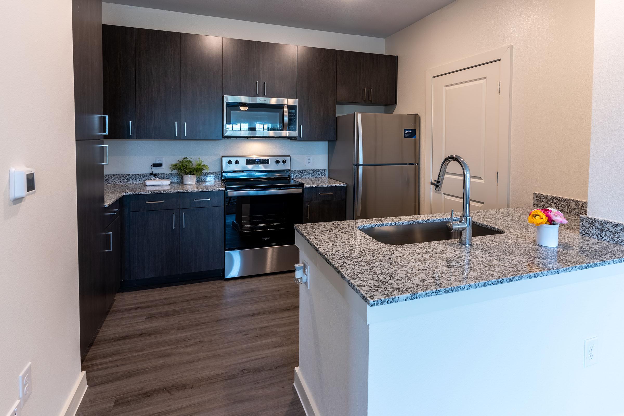 a kitchen with a stove sink and refrigerator