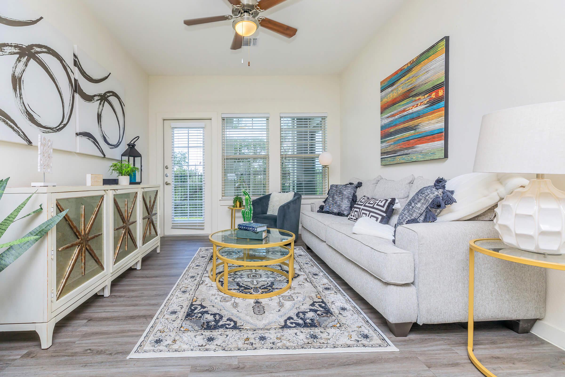 a living room filled with furniture and a large window