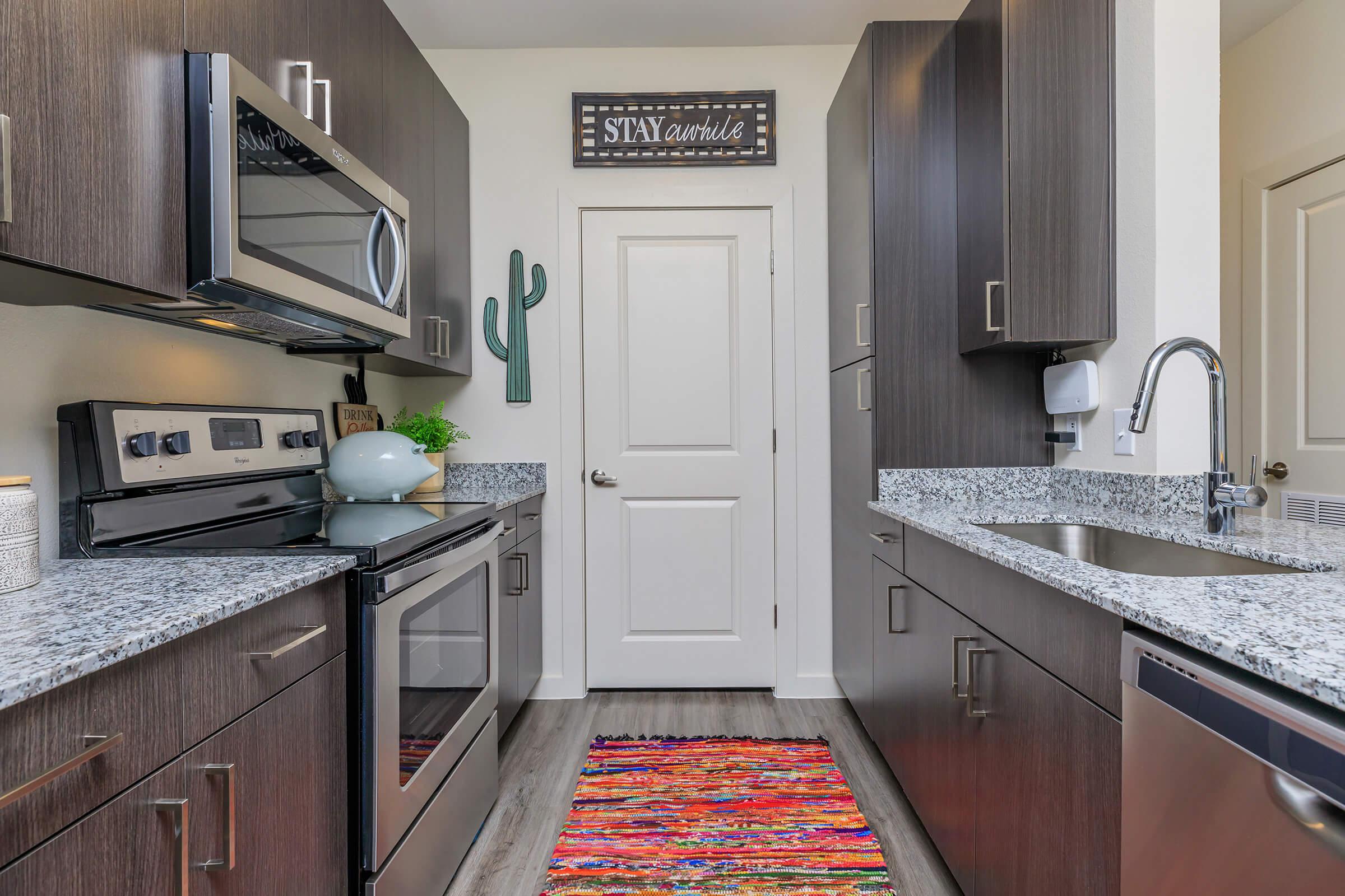 a kitchen with a sink and a mirror