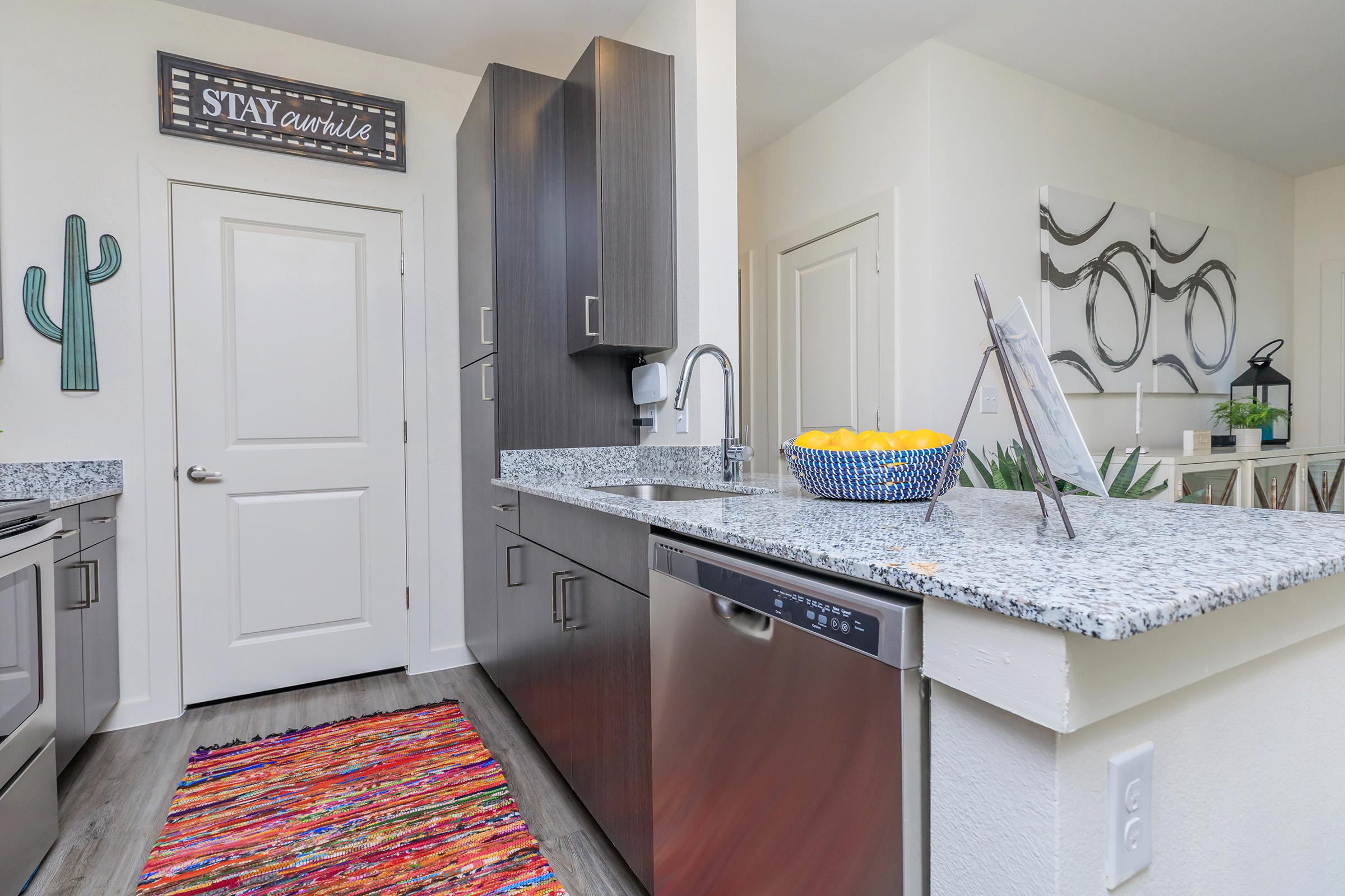 a kitchen with a sink and a mirror