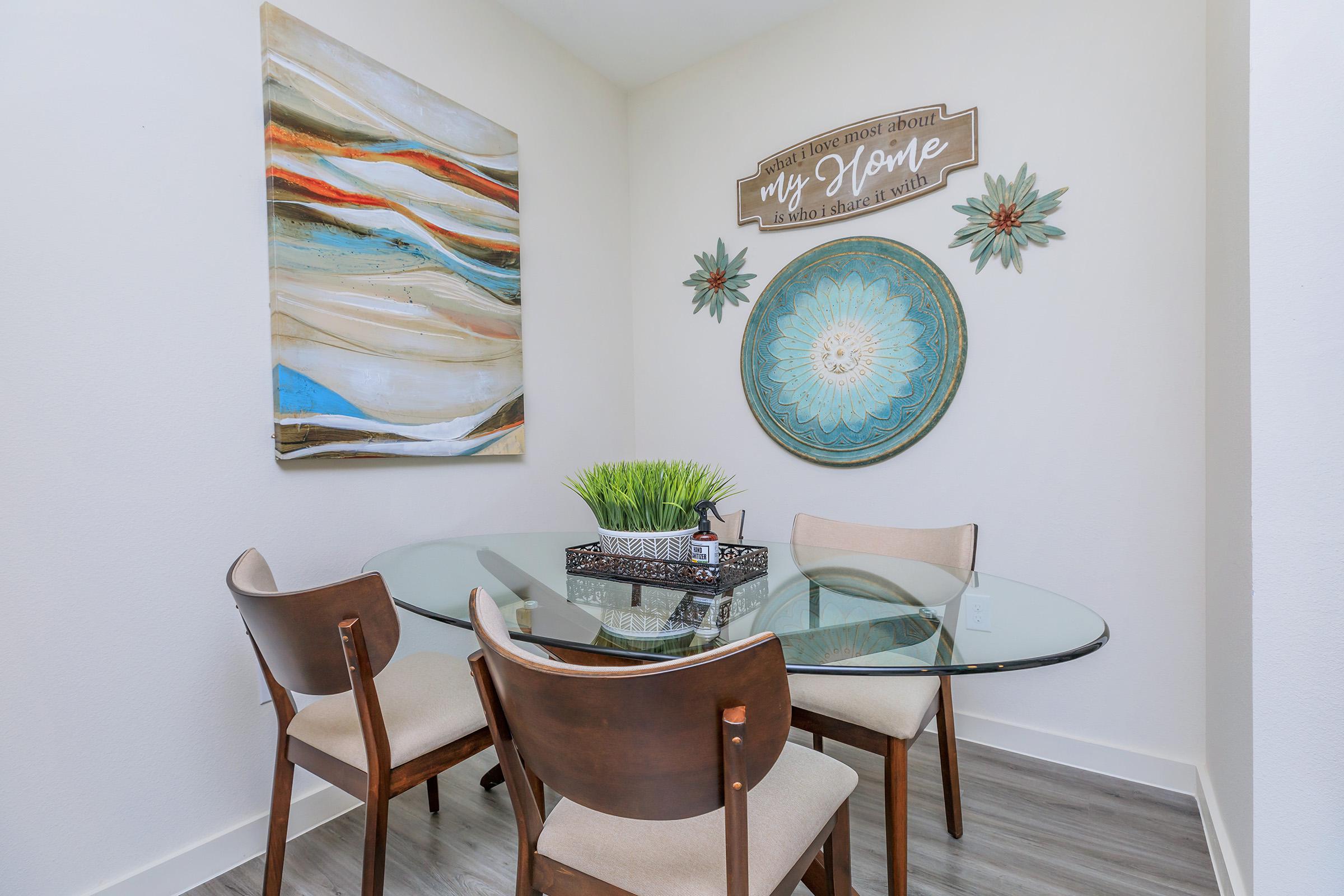 a room filled with furniture and vase of flowers on a table