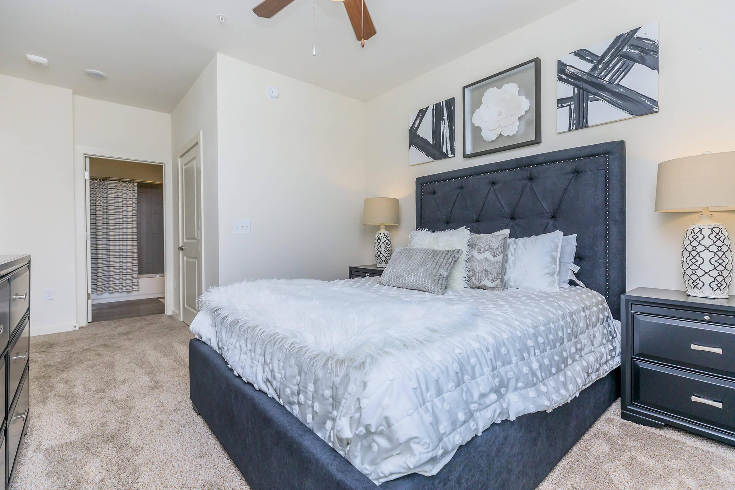 a bedroom with a bed and desk in a room