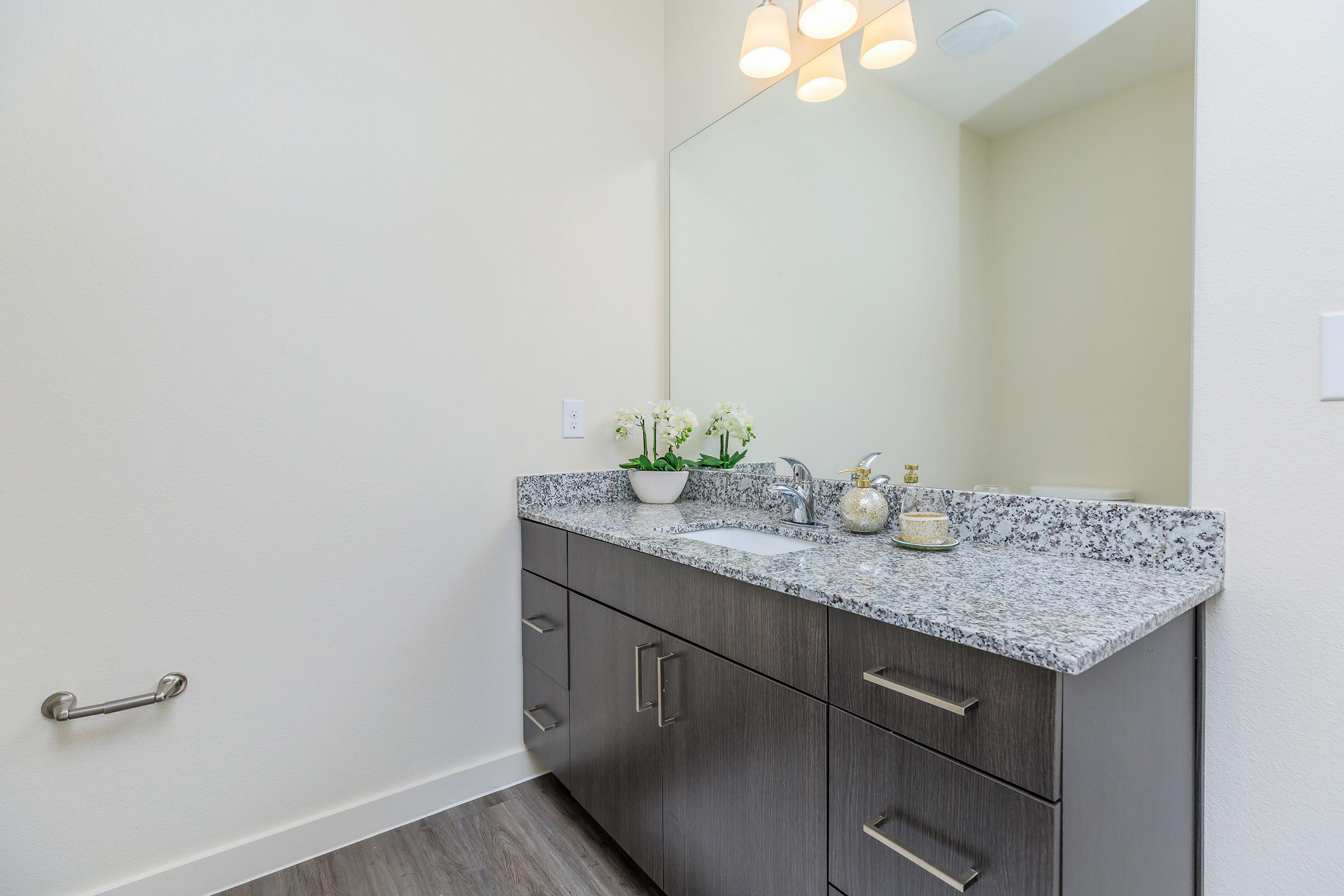 a kitchen with a sink and a mirror