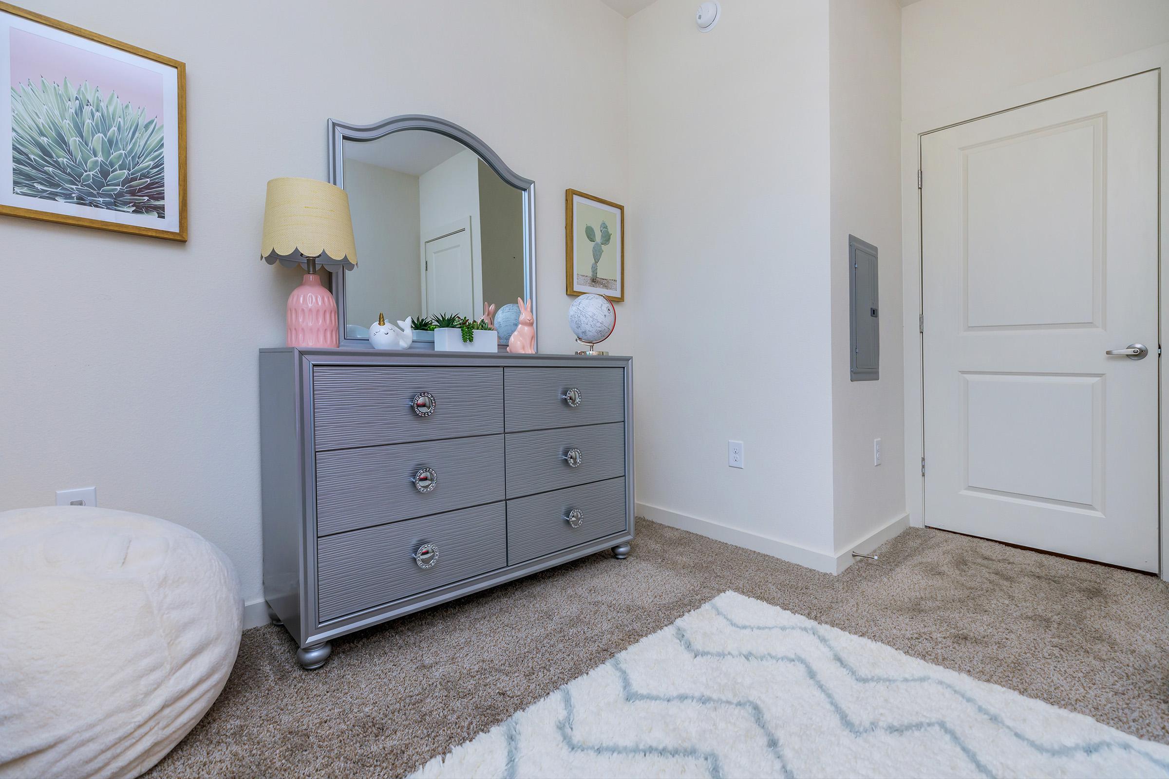 a bedroom with a bed and desk in a small room