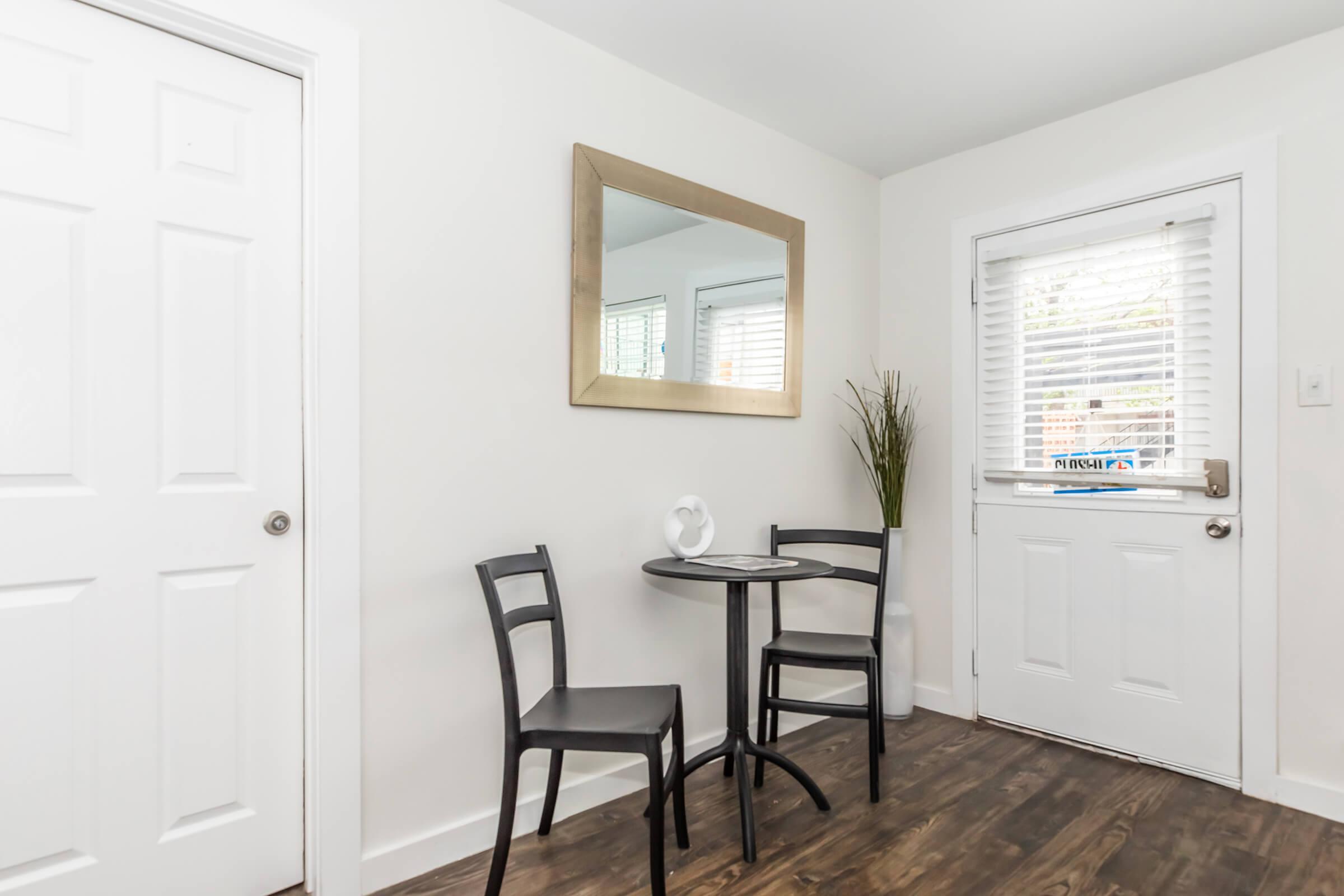 a room filled with furniture and a large window