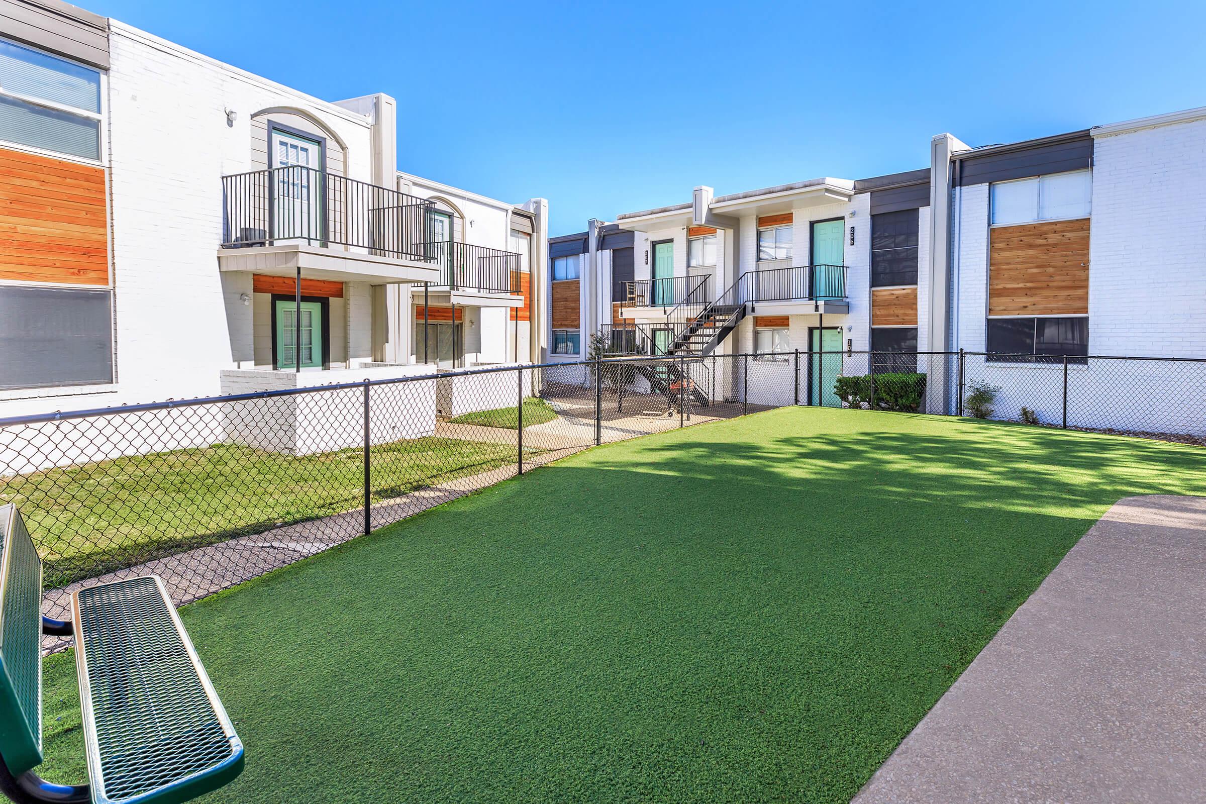 a house with a lawn in front of a building