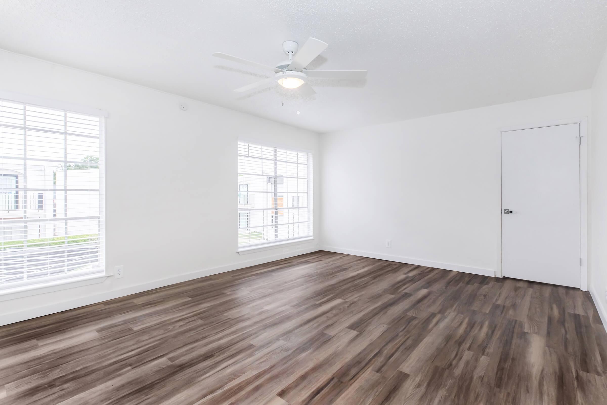 a large empty room with a wooden floor