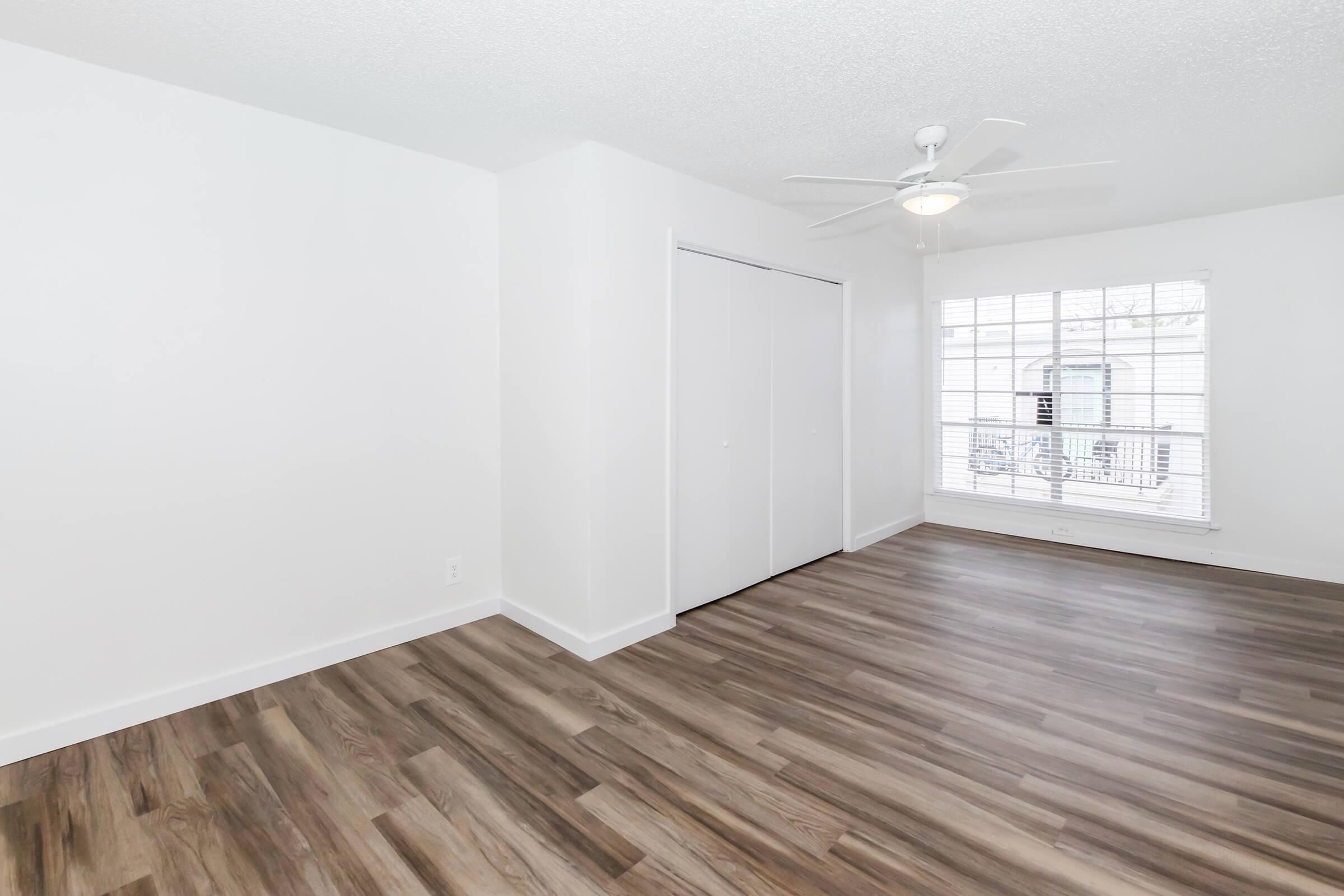 a large empty room with a wood floor