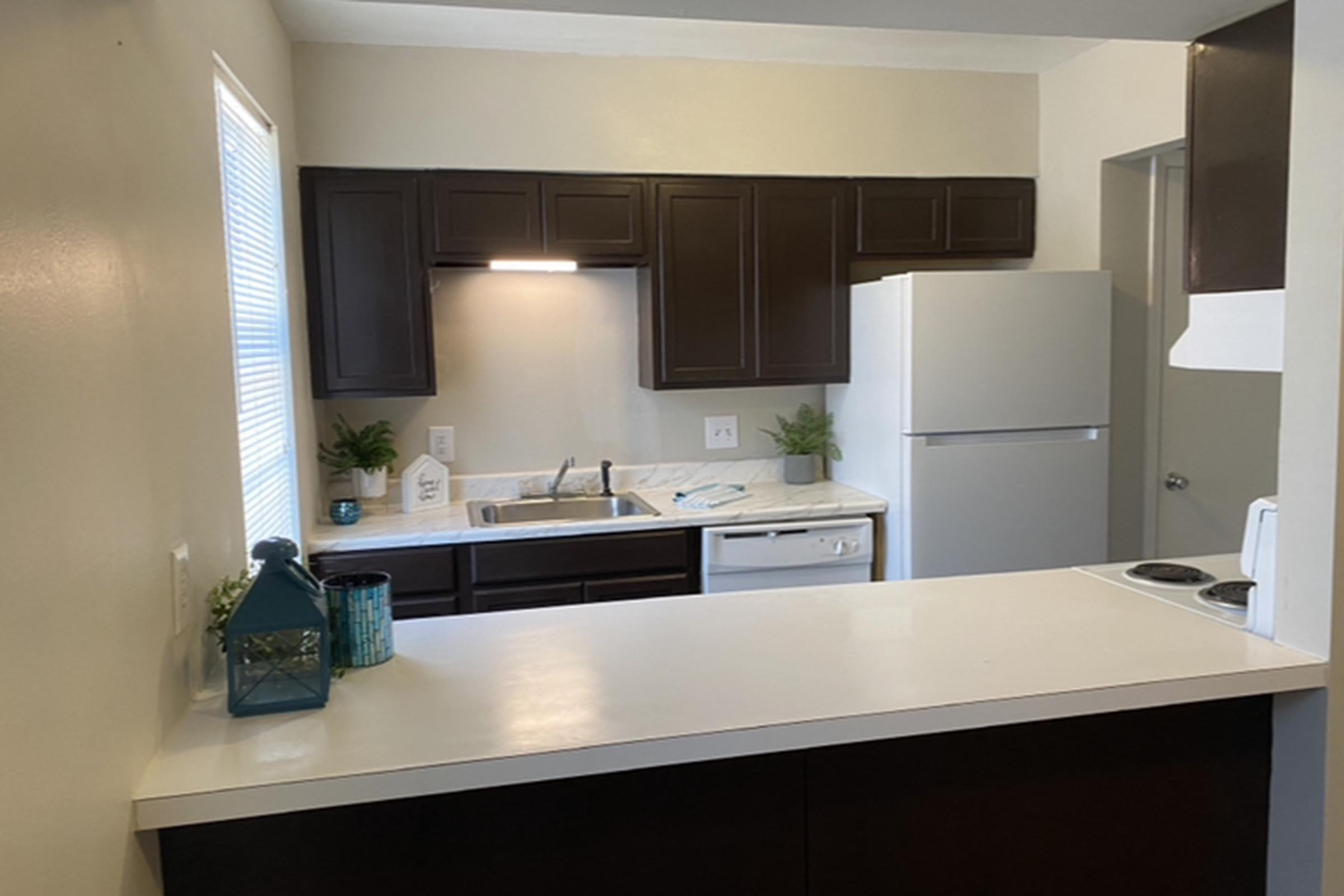 a kitchen with a sink and a mirror