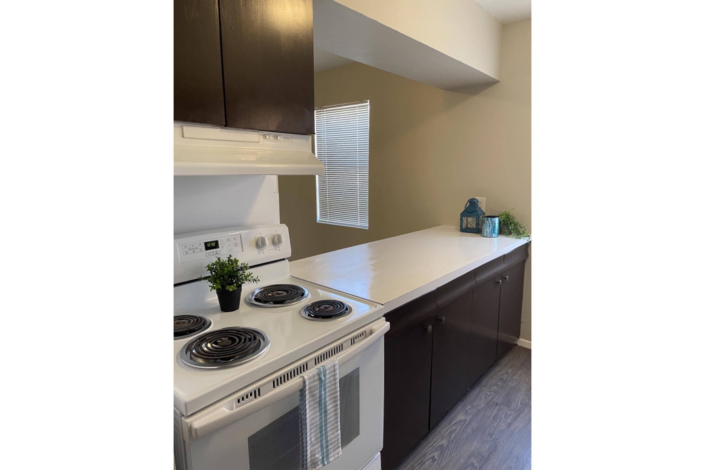 a stove top oven sitting inside of a kitchen