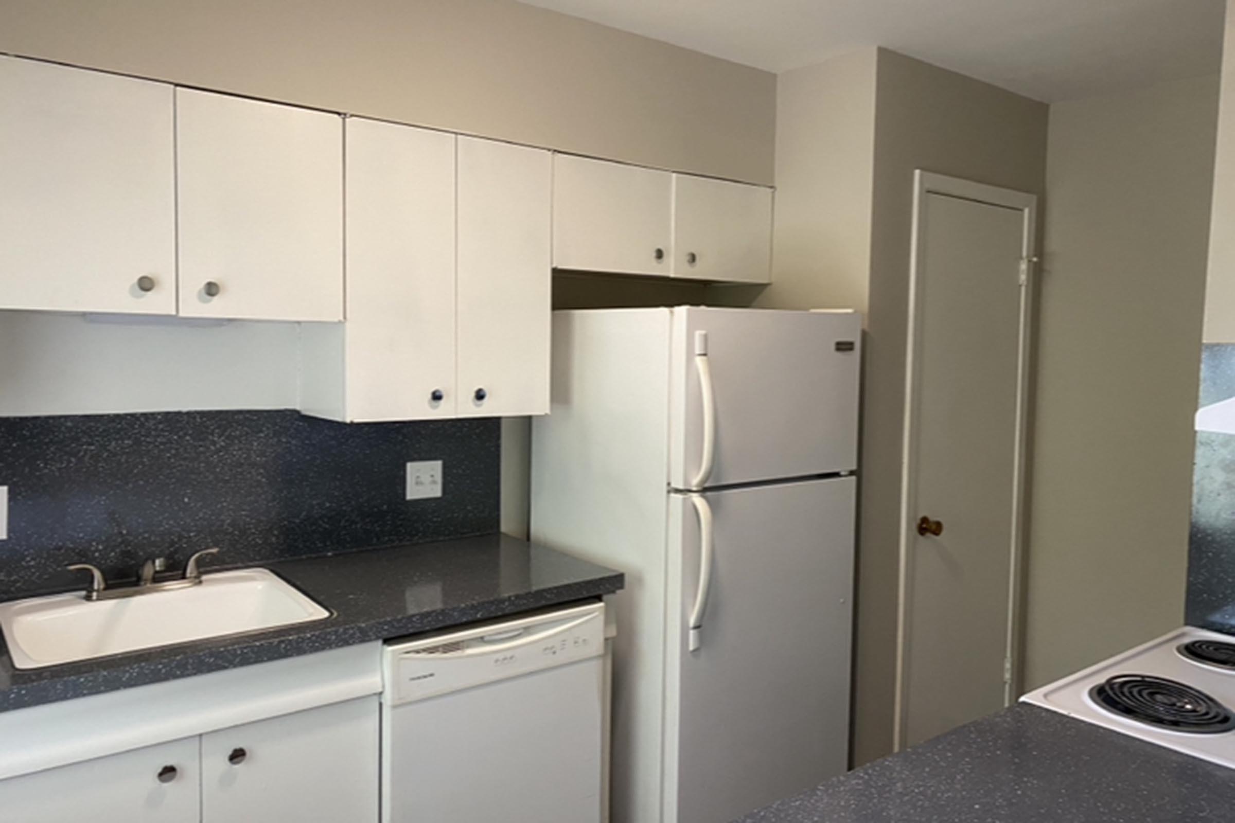 a kitchen with a sink and a refrigerator