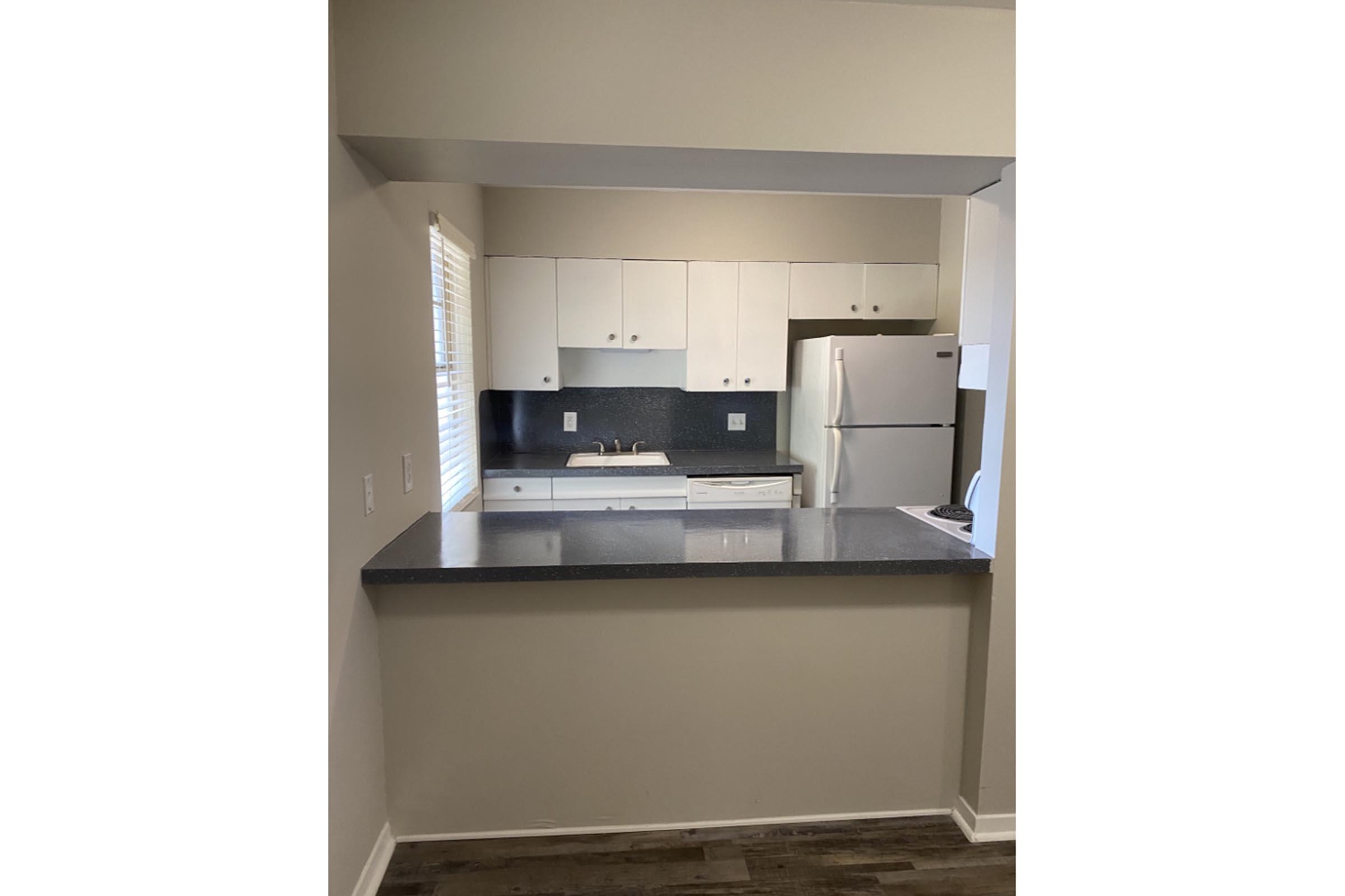 a kitchen with a stove and a refrigerator