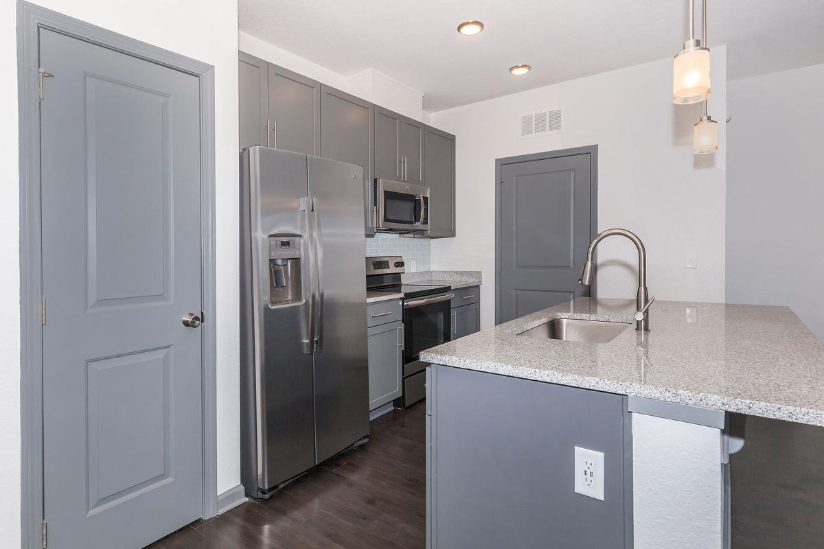 a kitchen with a sink and a refrigerator