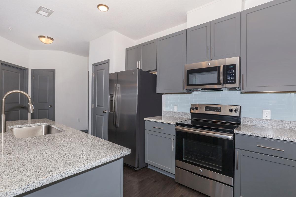 a kitchen with a sink and a refrigerator