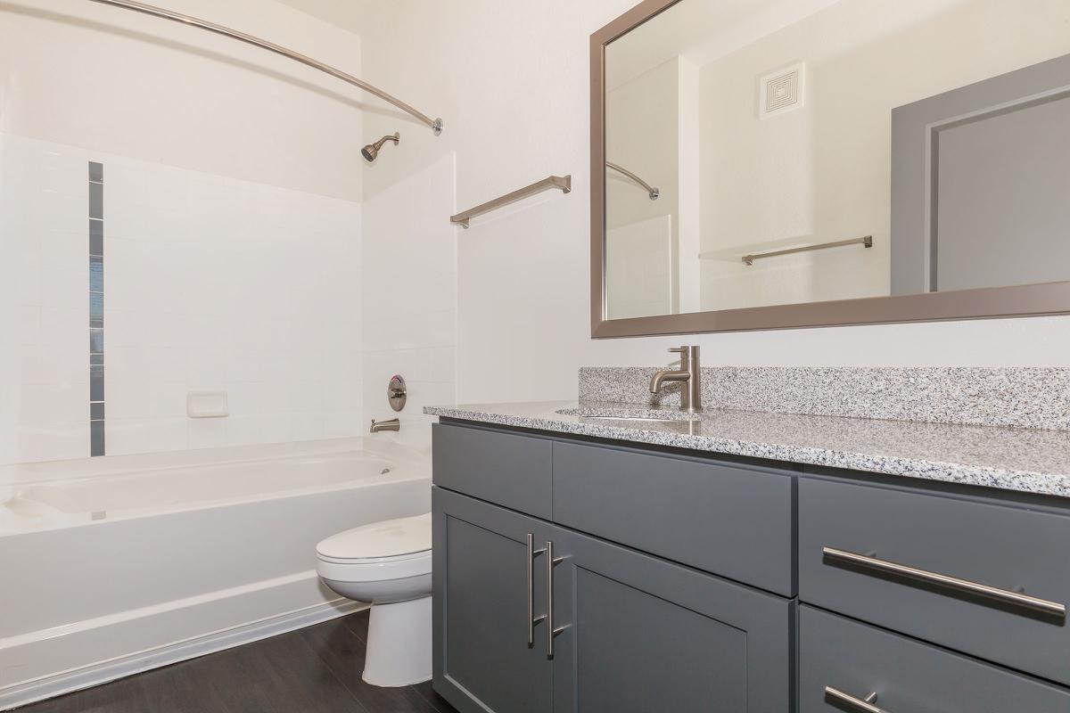 a kitchen with a sink and a mirror