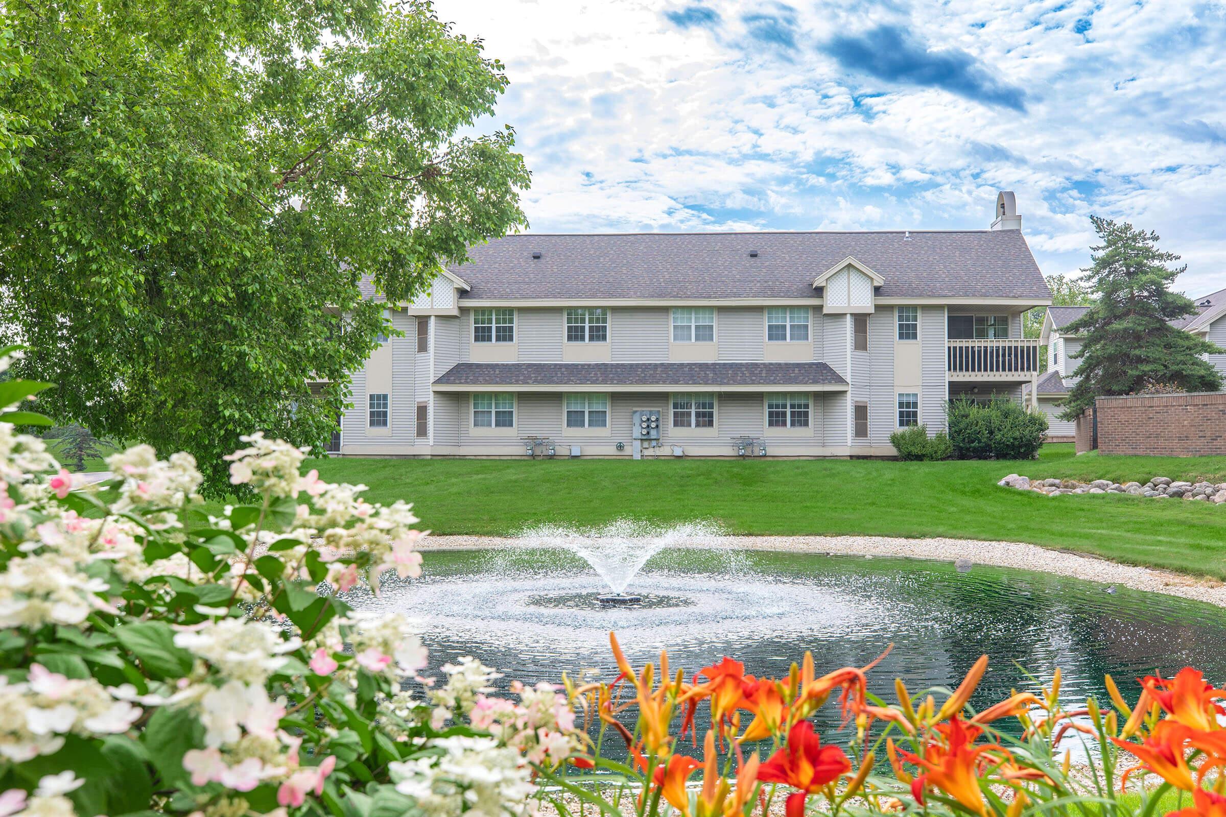 a close up of a flower garden in front of a building