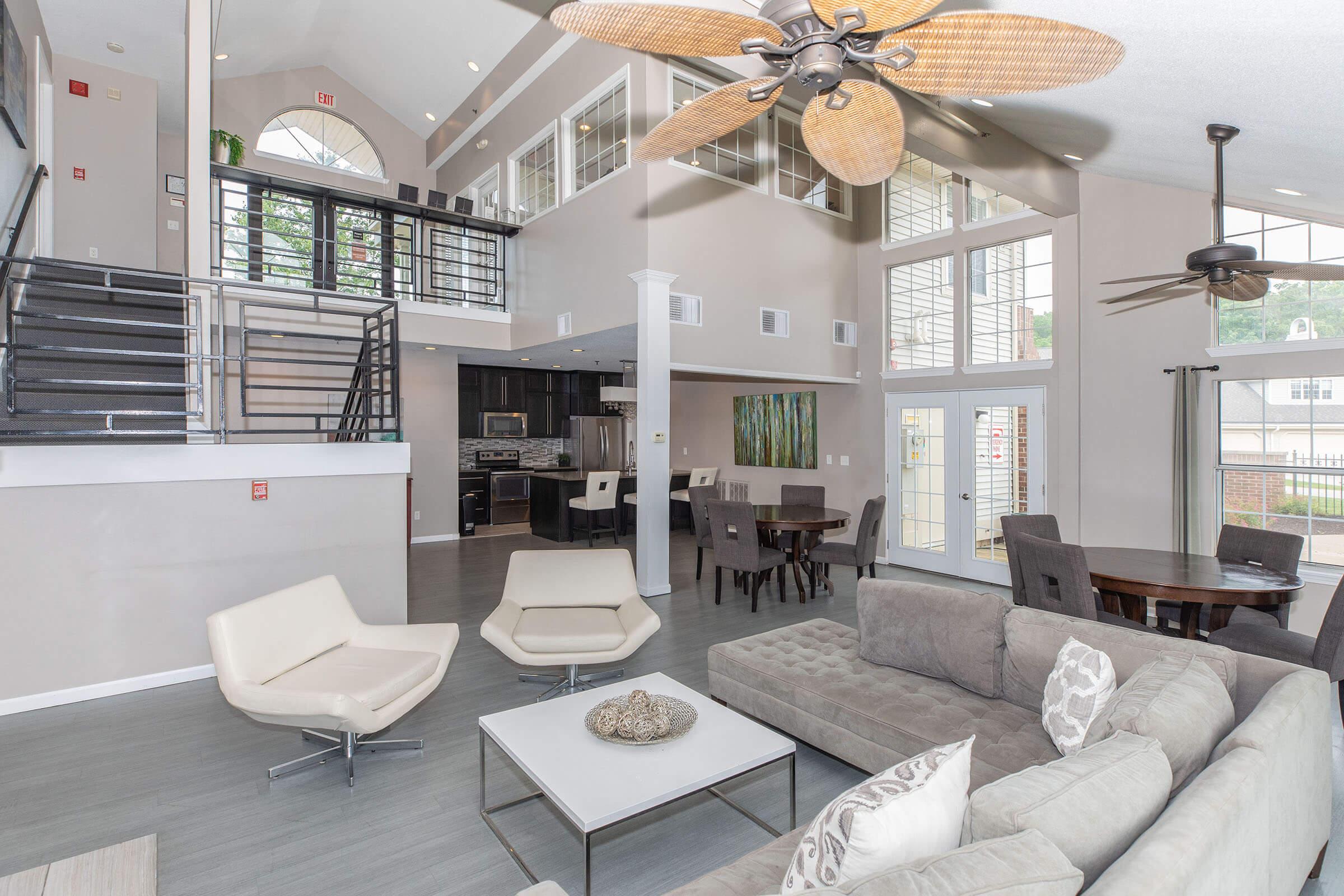 a living room filled with furniture and a large window