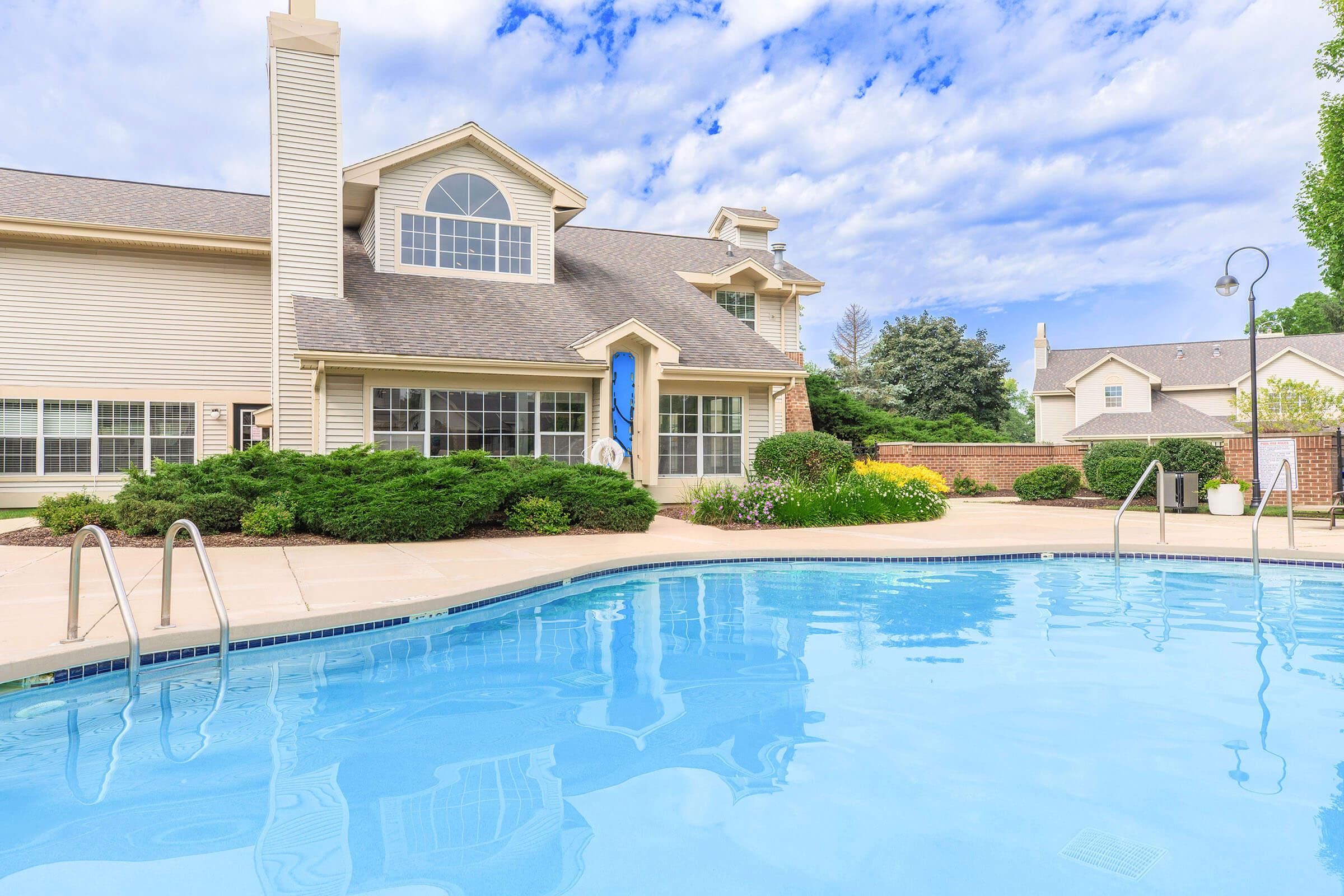 a large pool of water in front of a house