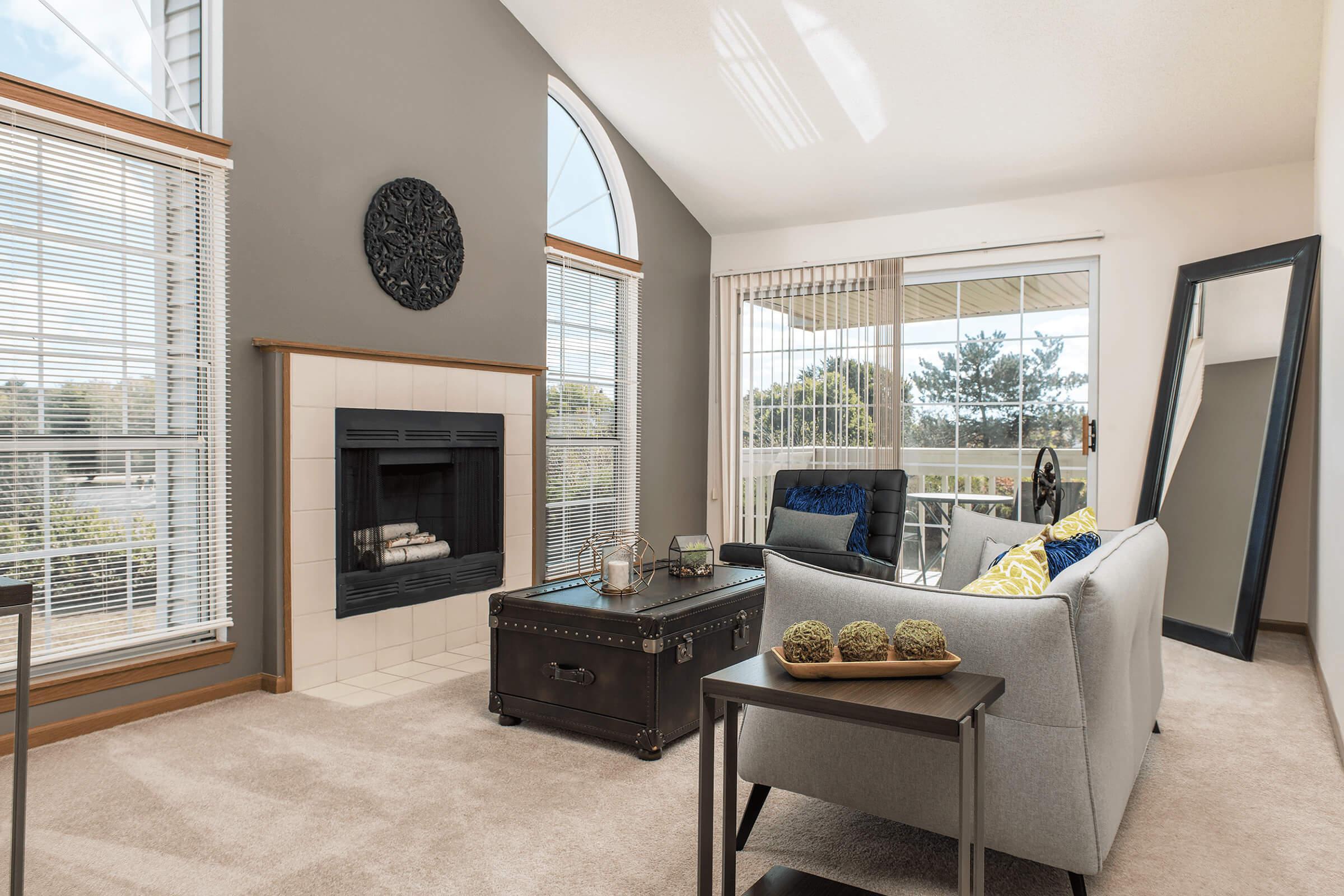 a living room filled with furniture and a large window