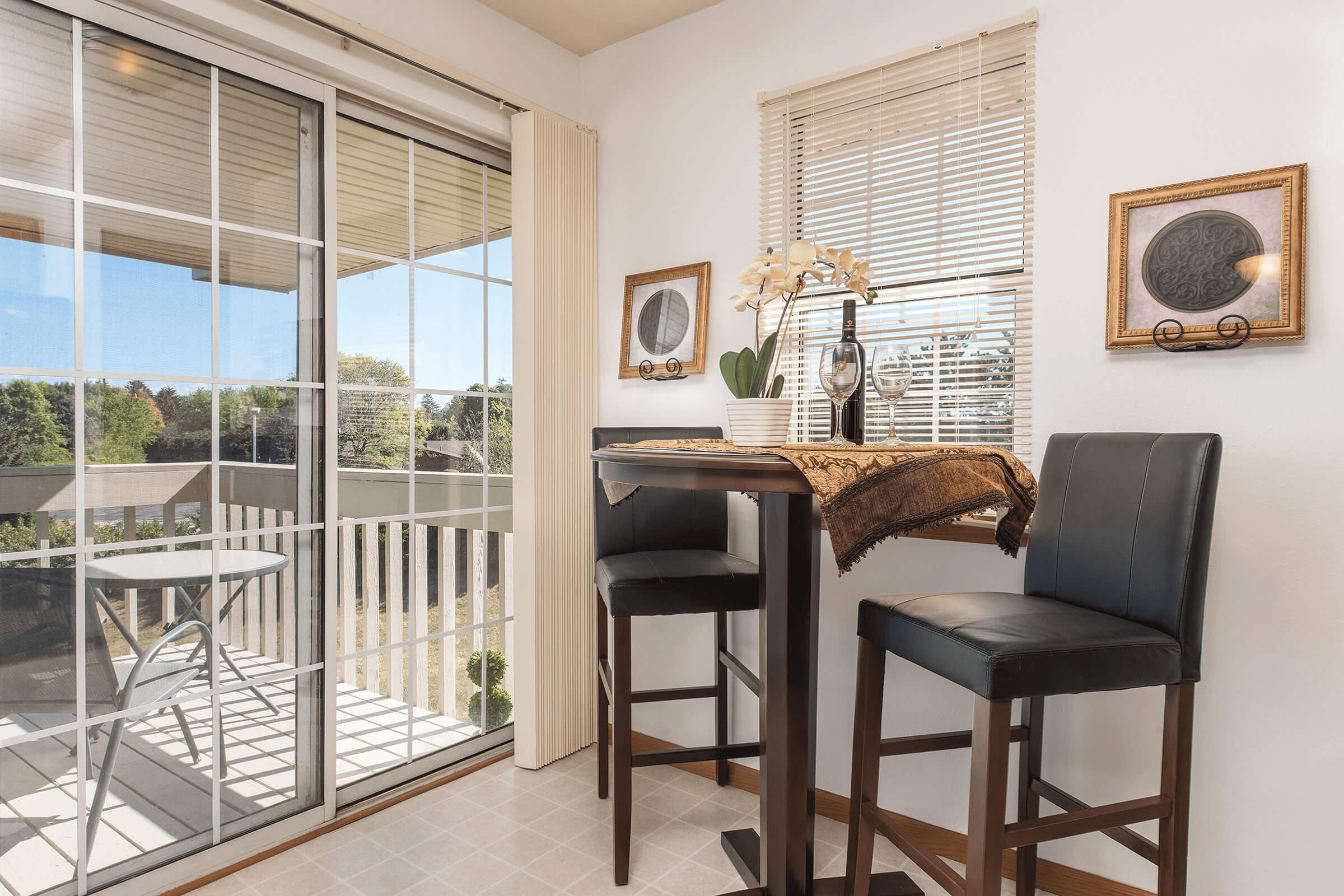 a dining room table in front of a window