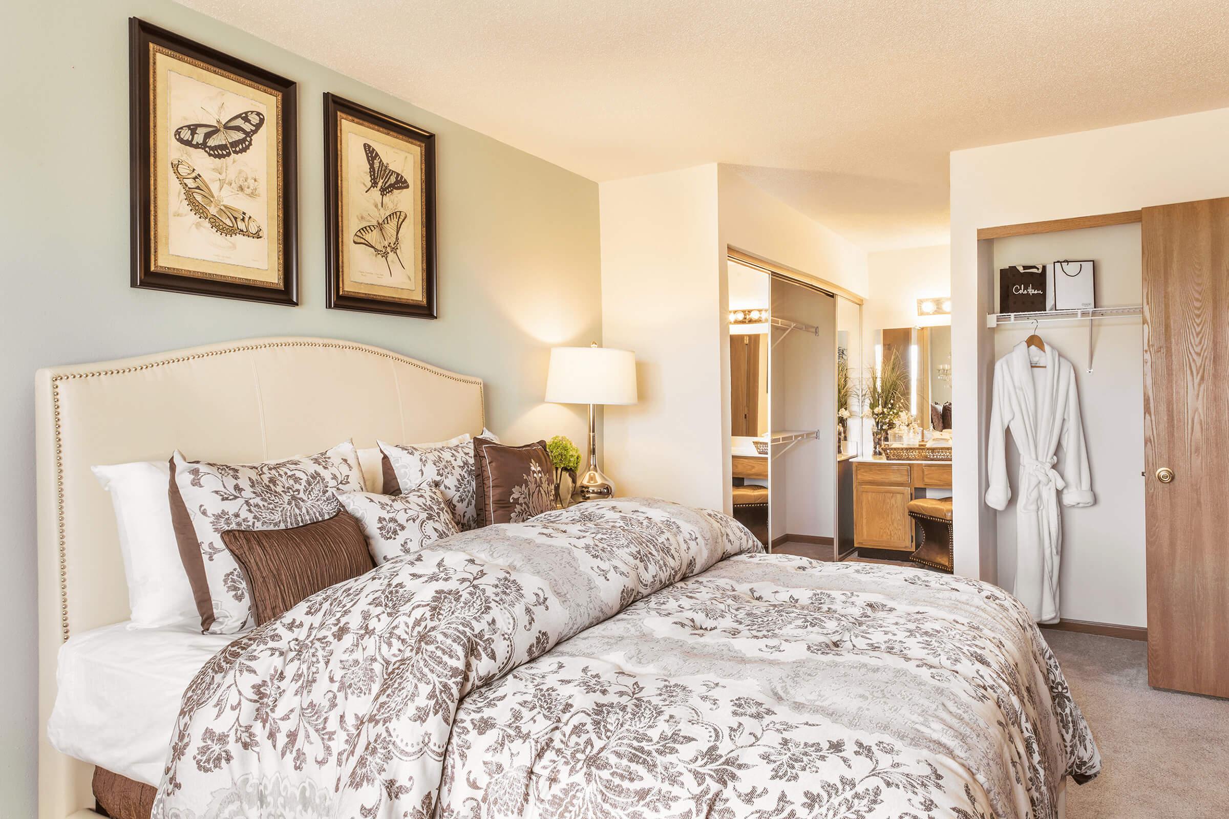 a bedroom with a large bed in a hotel room