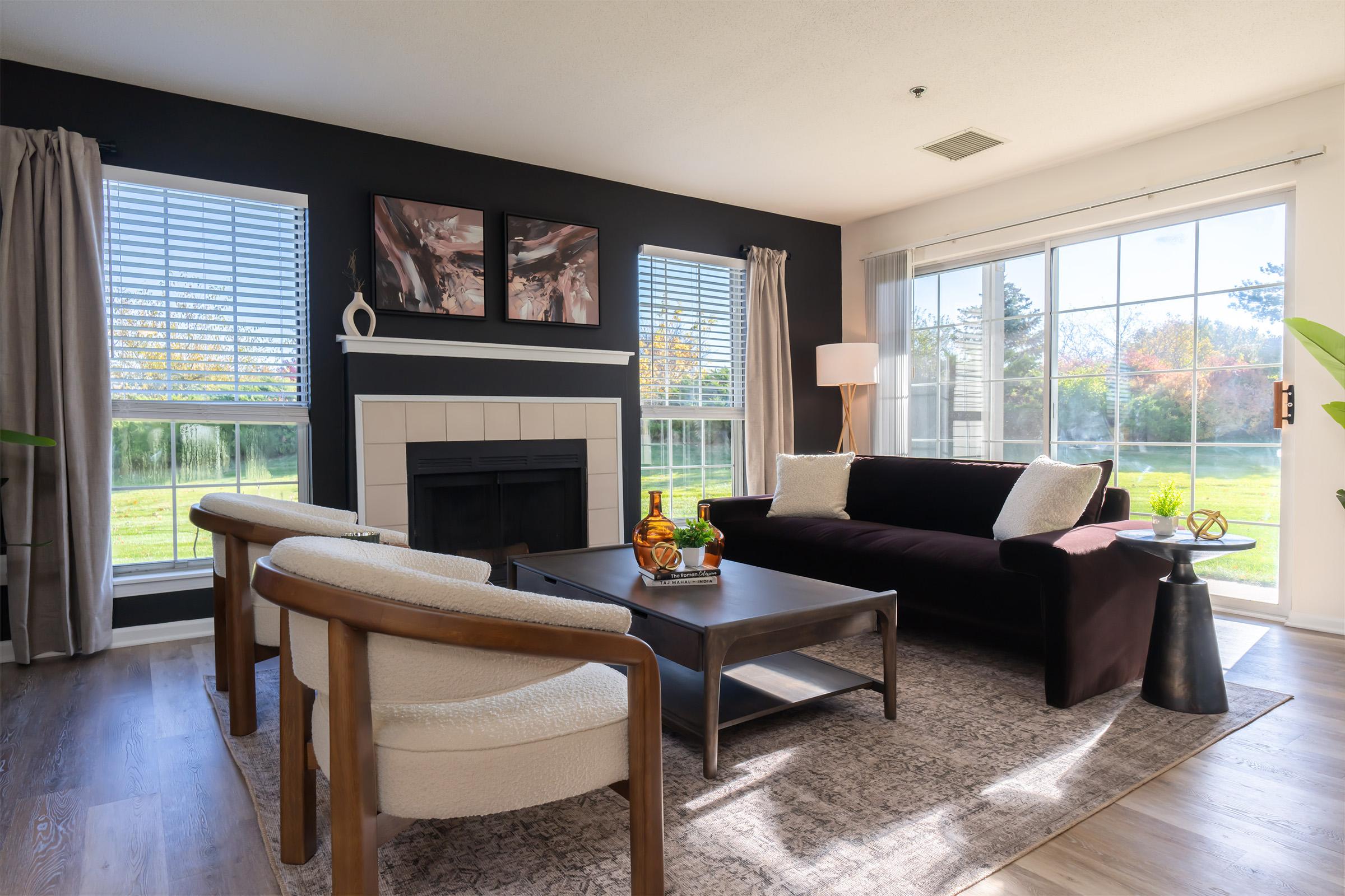 a living room filled with furniture and a large window