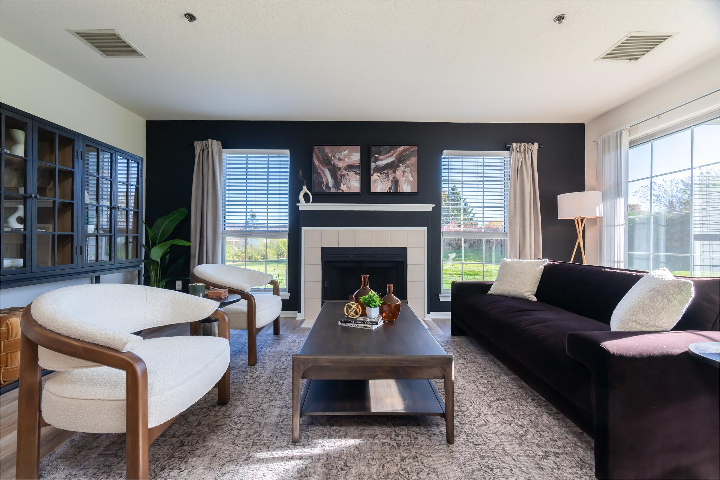 a living room filled with furniture and a large window