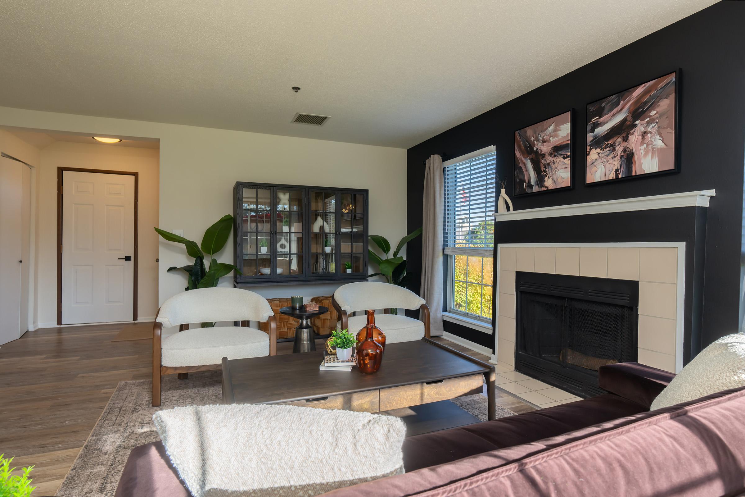 a living room filled with furniture and a fire place