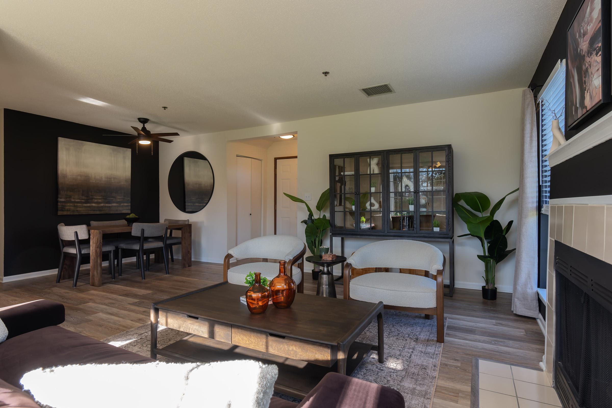 a living room filled with furniture and a flat screen tv