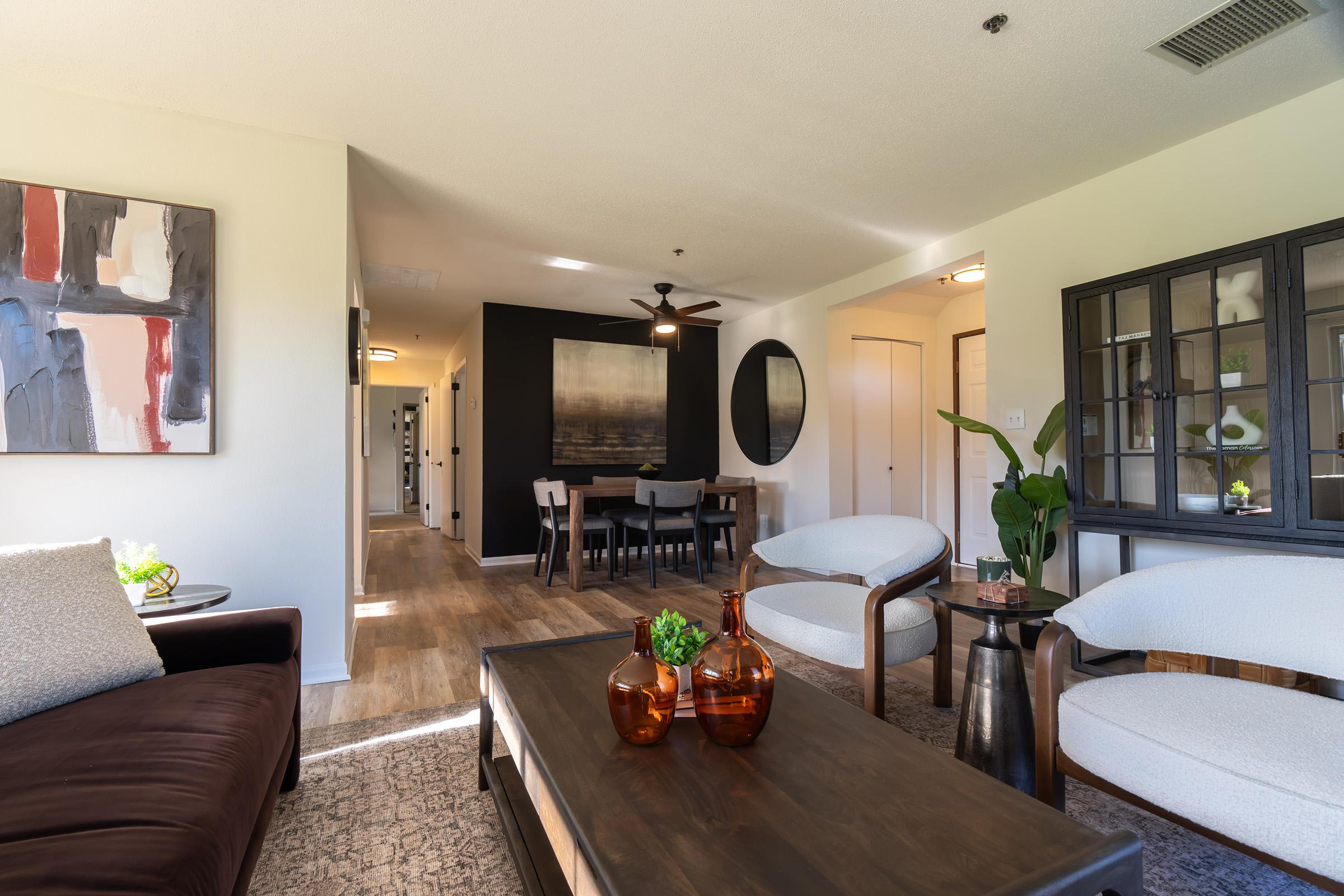 a living room filled with furniture and a flat screen tv