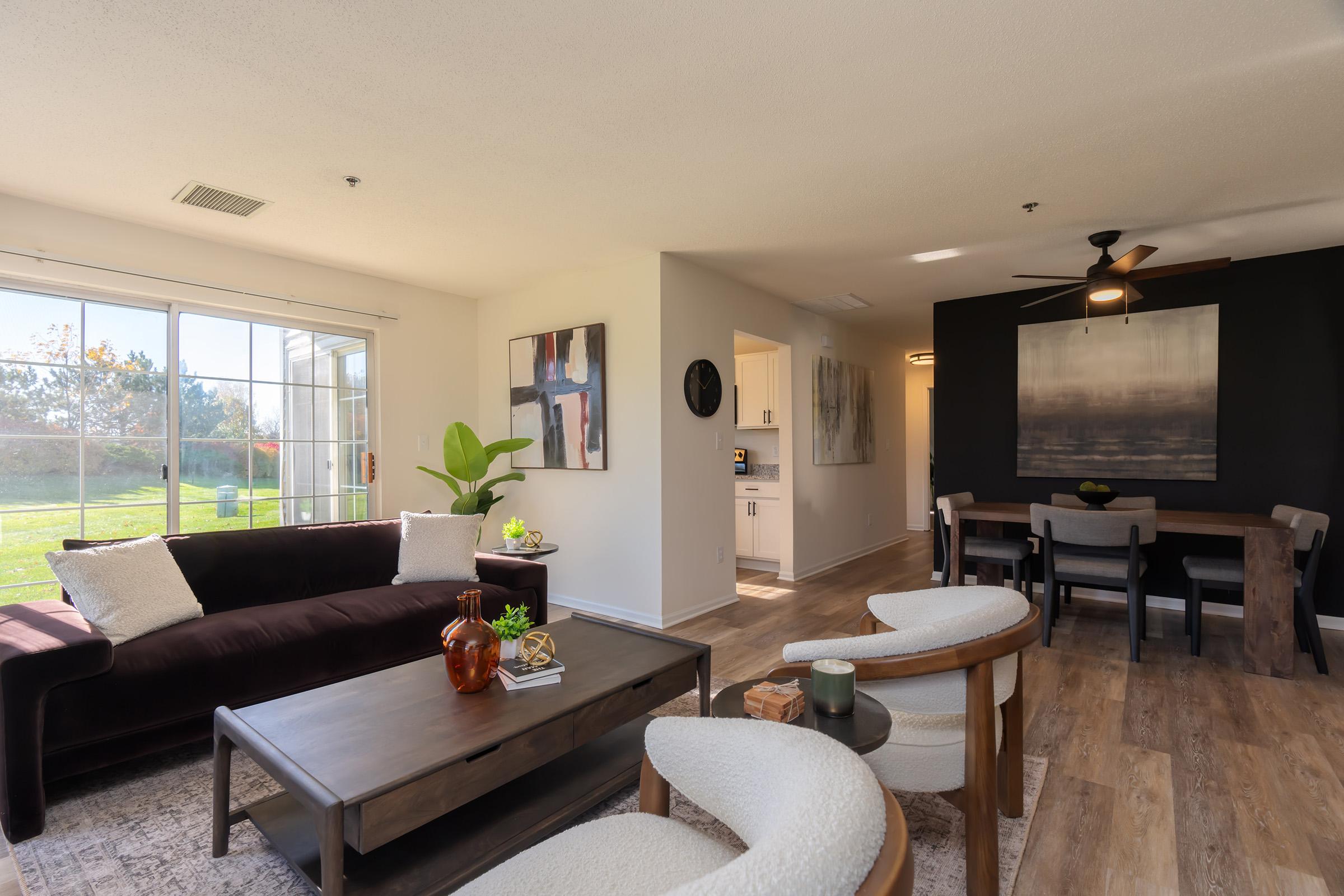 a living room filled with furniture and a flat screen tv