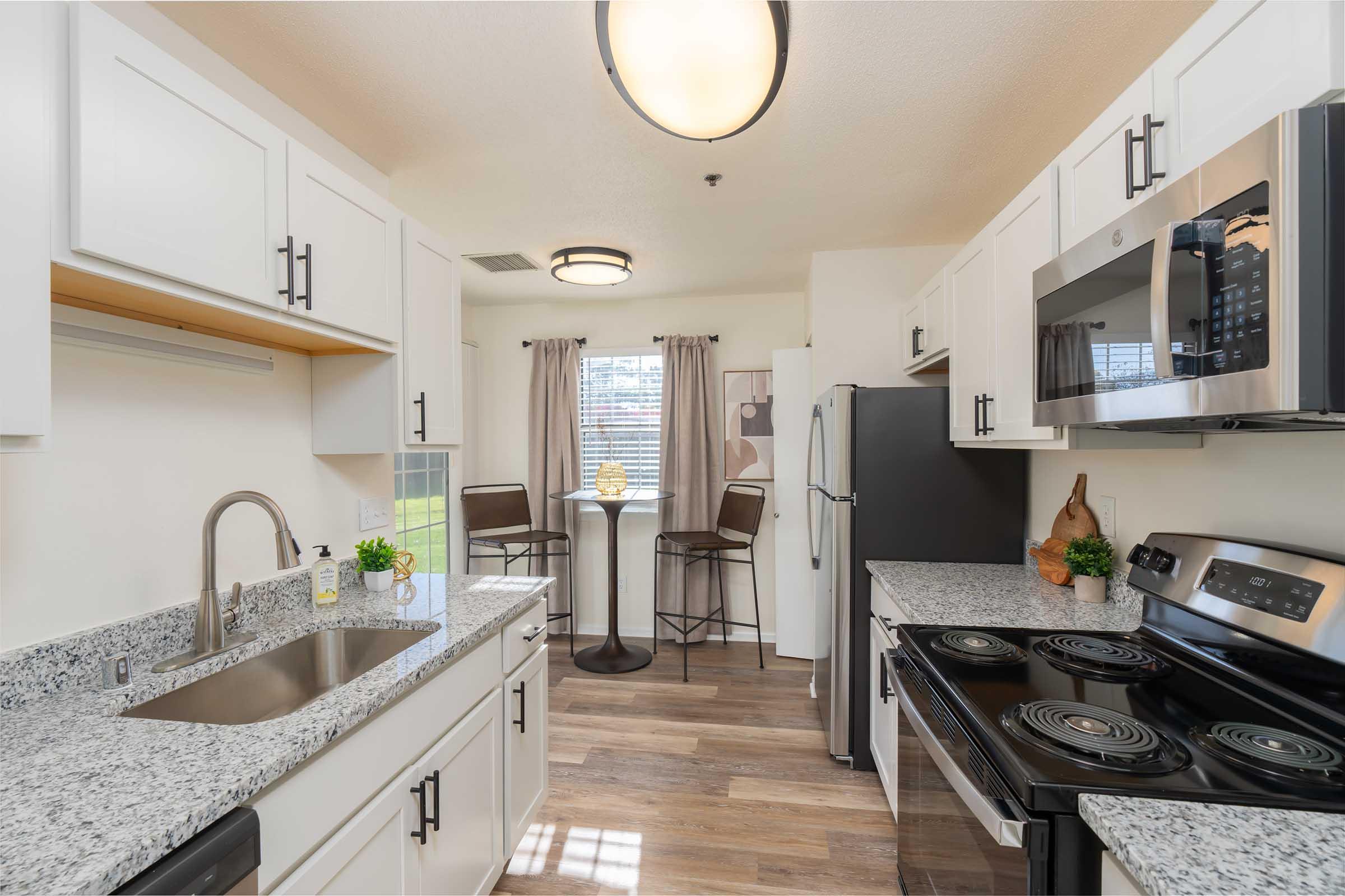 a kitchen with a sink and a counter in a room